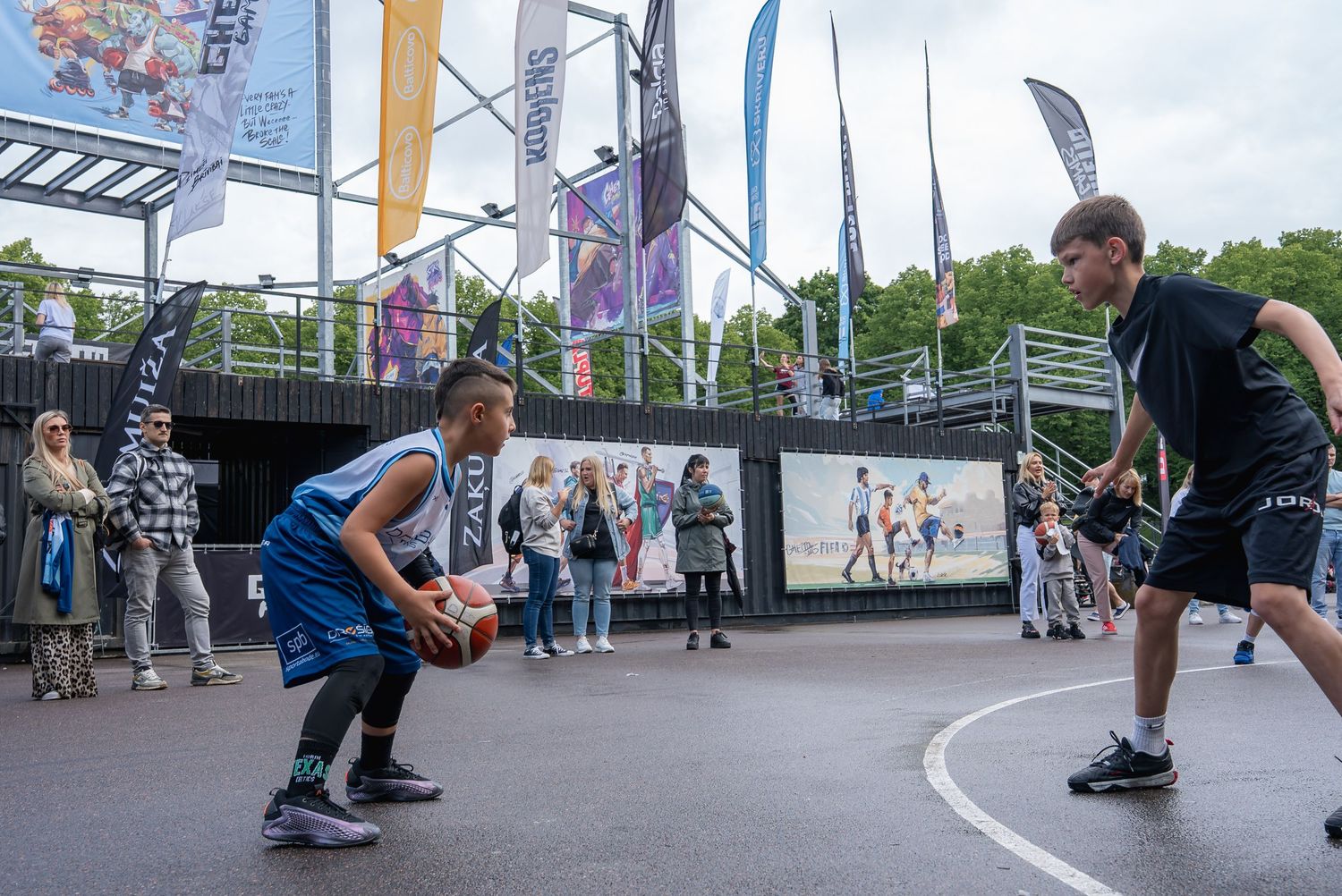 People performing skateboarding tricks and jumps at an outdoor skate park.