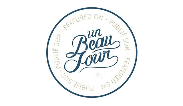 Circular badge logo for Un Beau Jour French wedding blog featuring elegant script typography in blue and white.