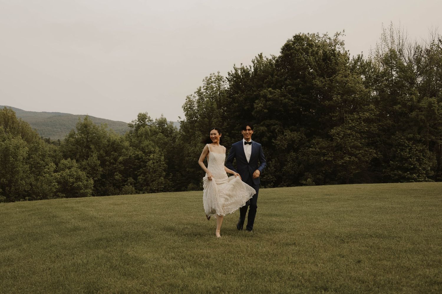 Newly wed running in a field