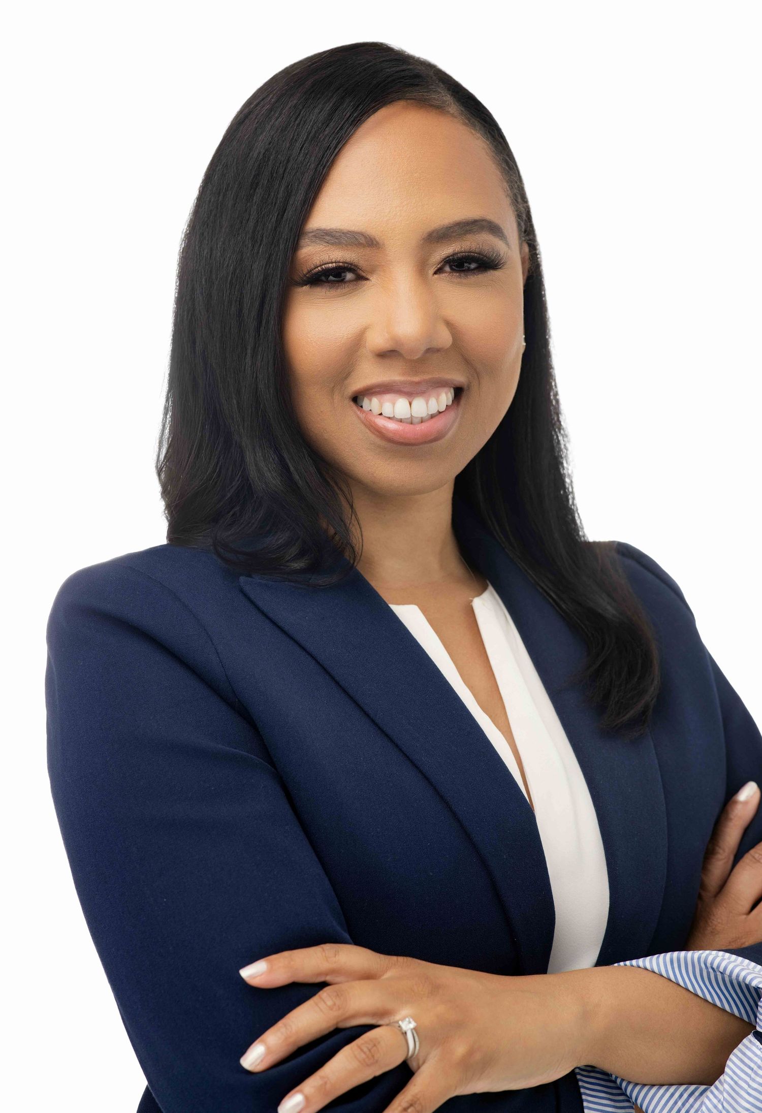Business portrait showing warm smile and professional navy blazer ensemble.