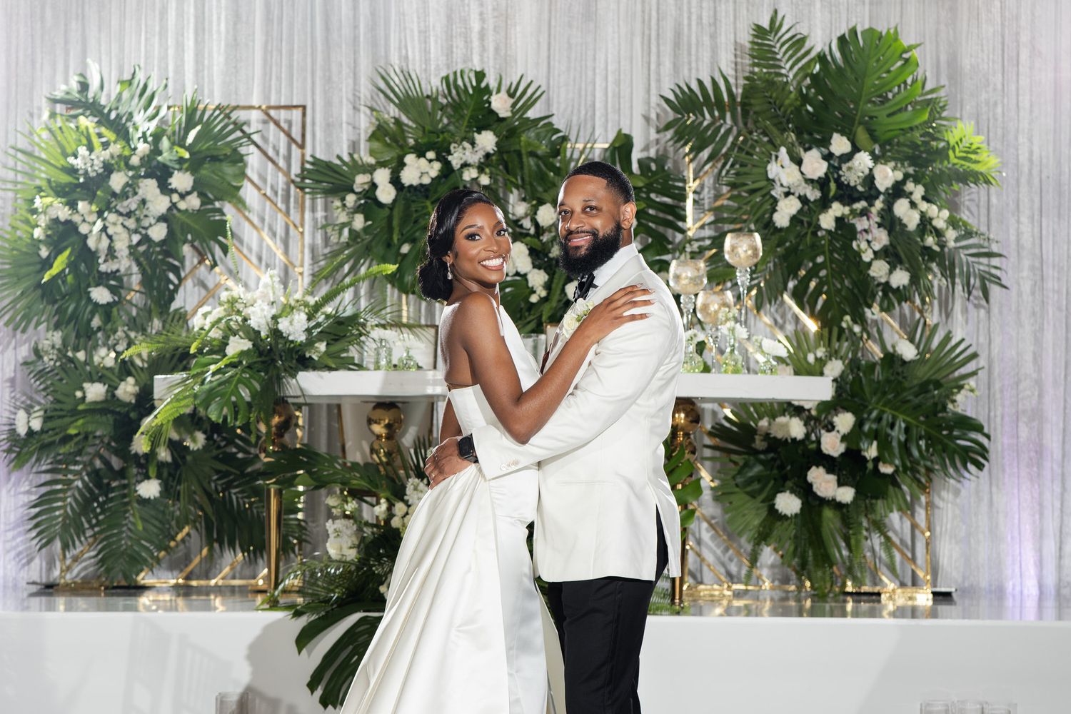 Elegant wedding celebration with white floral arrangements and decorative greenery adorning the venue.