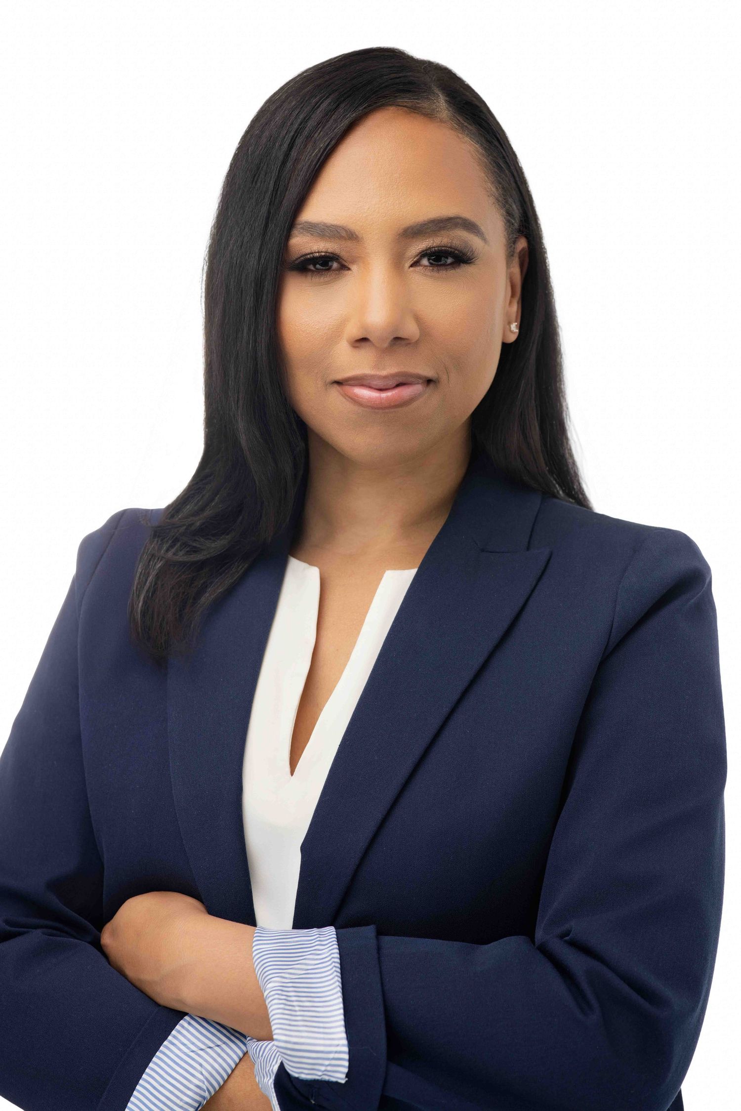 Professional headshot of person in navy blazer and white blouse against white background.