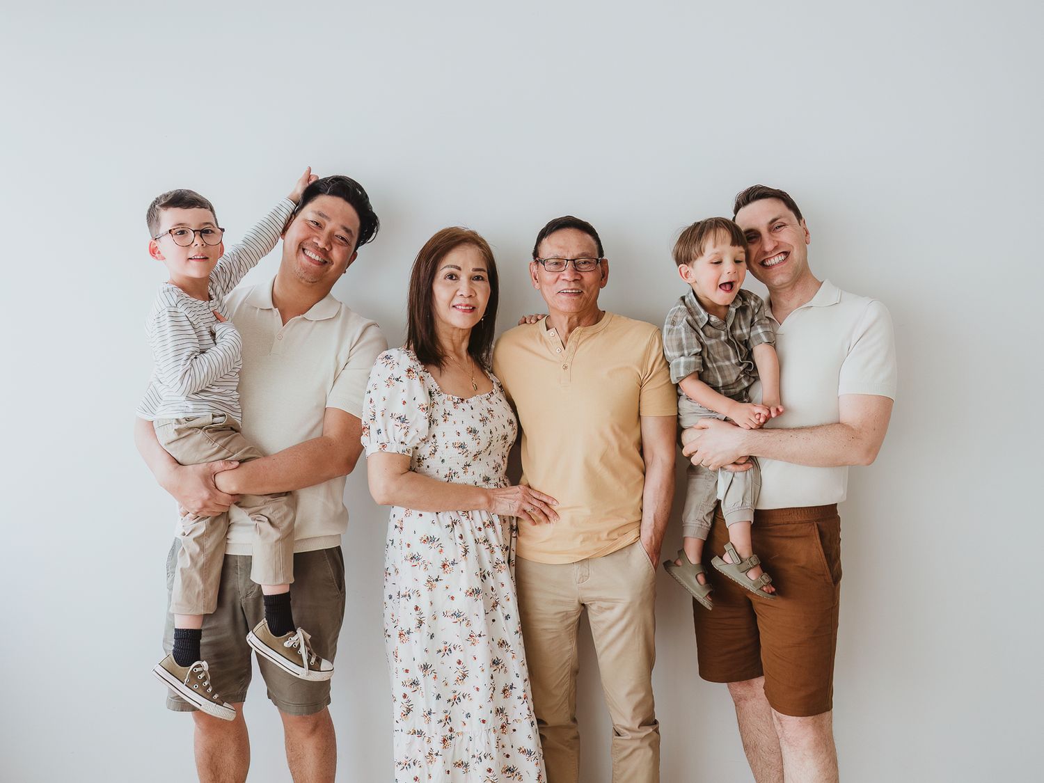 Extended family portrait with grandparents, adult children, grandchildren, and family dog during a studio session with a Spruce Grove family