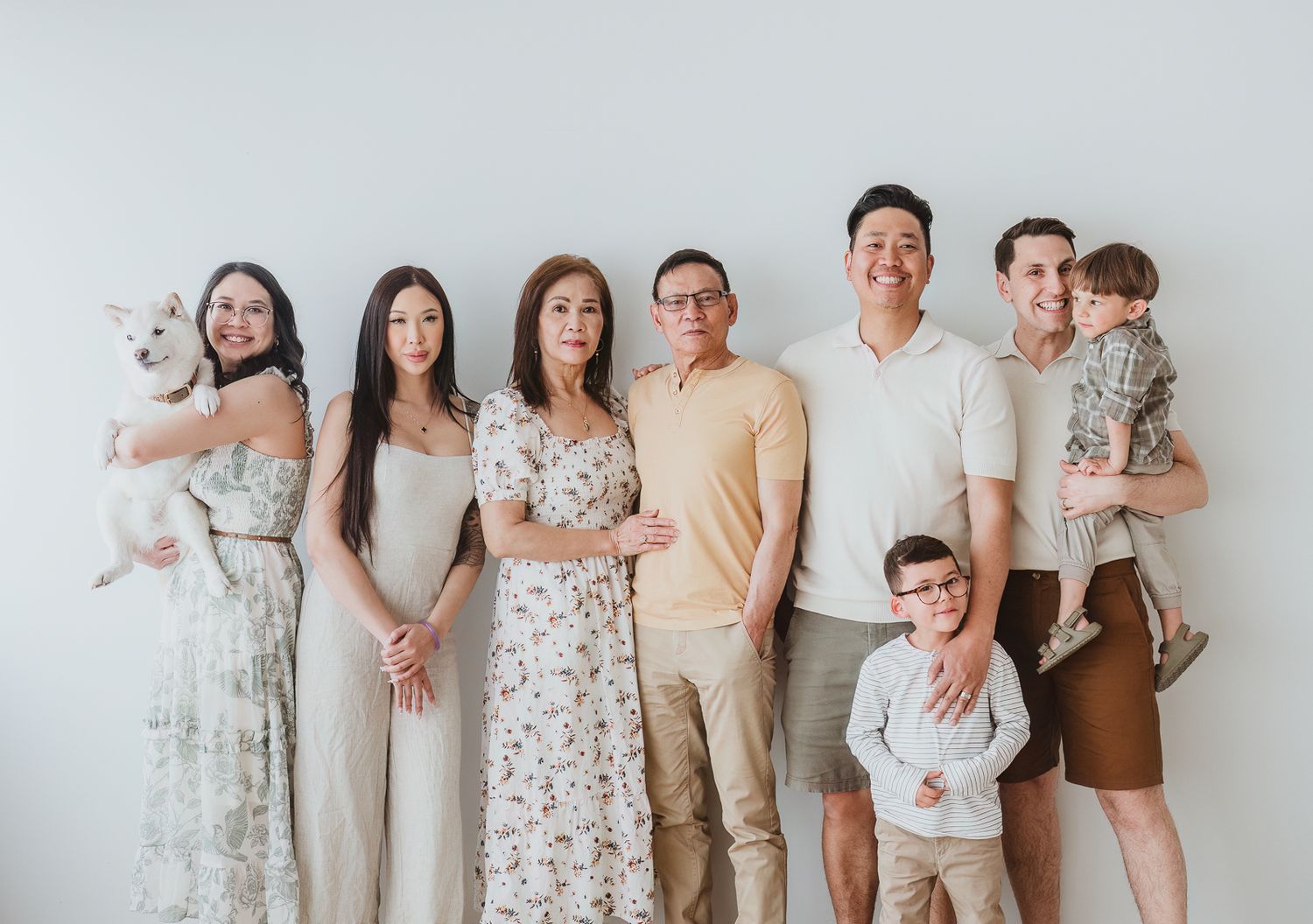 Multi-generational extended family portrait with grandparents, grandchildren, adult children, and family dog photographed by a Spruce Grove