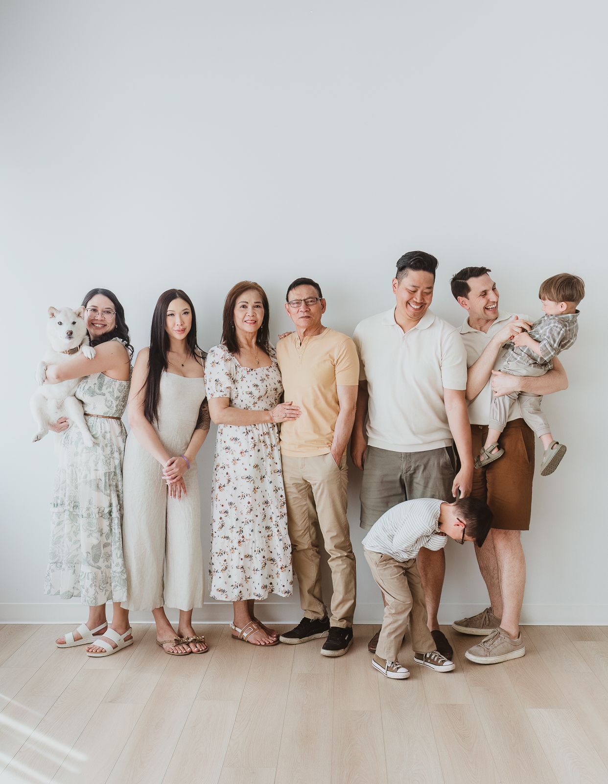 Extended family portrait with grandparents, adult children, grandchildren, and family dog during a studio session with a Spruce Grove family