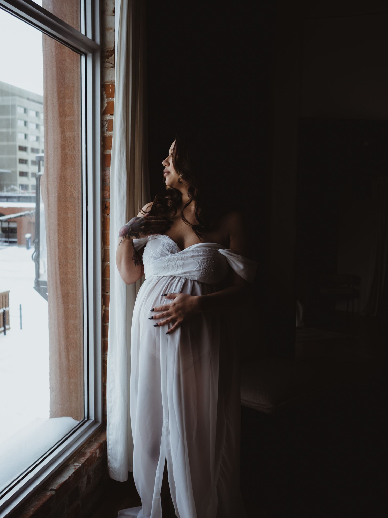 Soft studio maternity portrait with window light