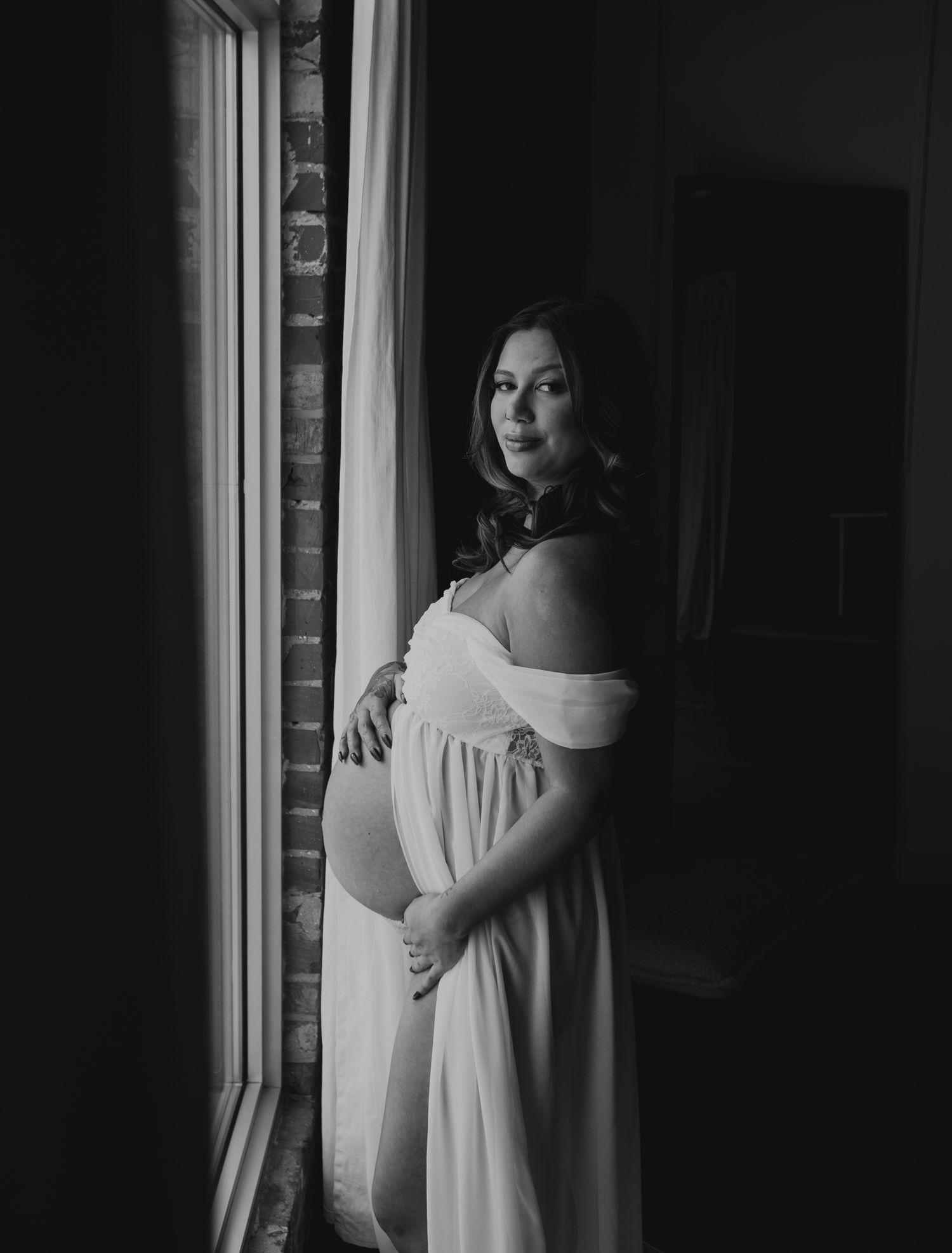 Soft studio maternity portrait with window light