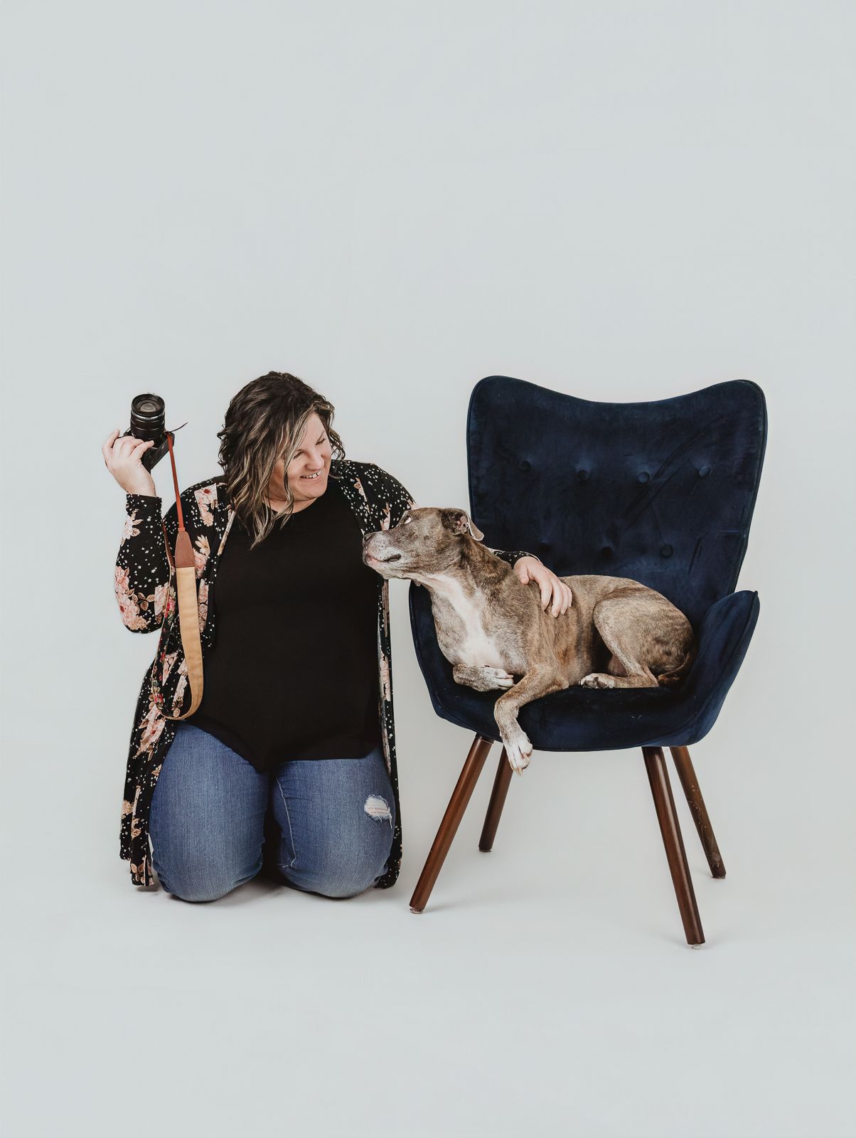 Spruce Grove dog photographer Coral Konanz sitting with a dog during a relaxed pet photography session