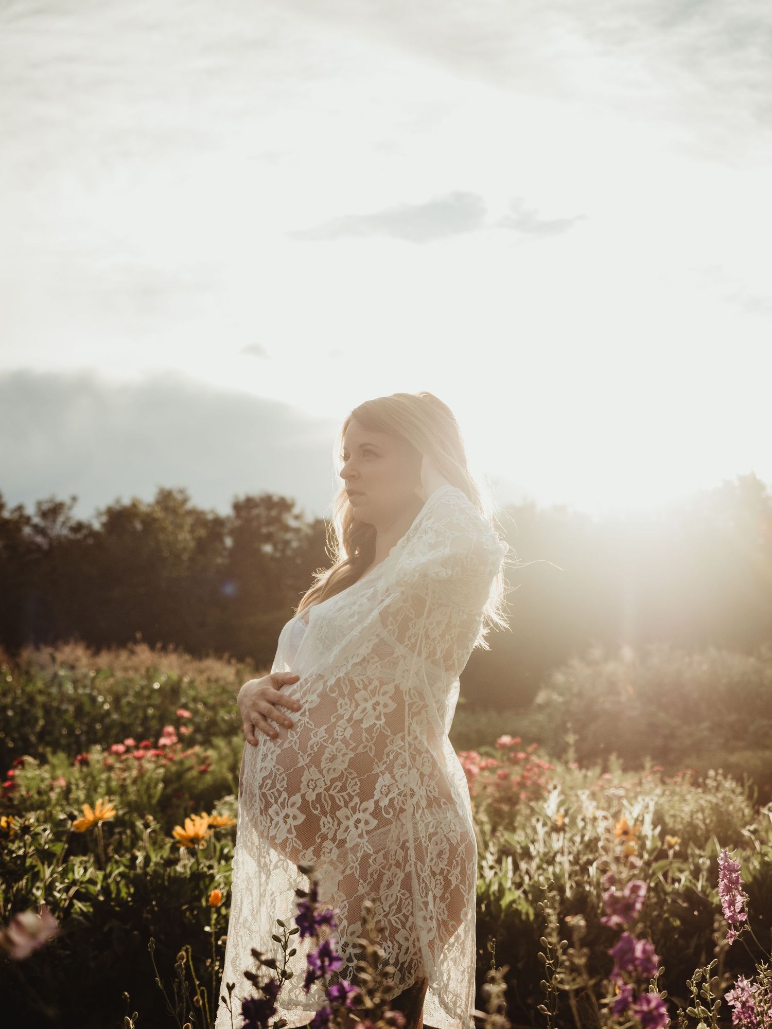 Maternity session in wildflower field at sunset