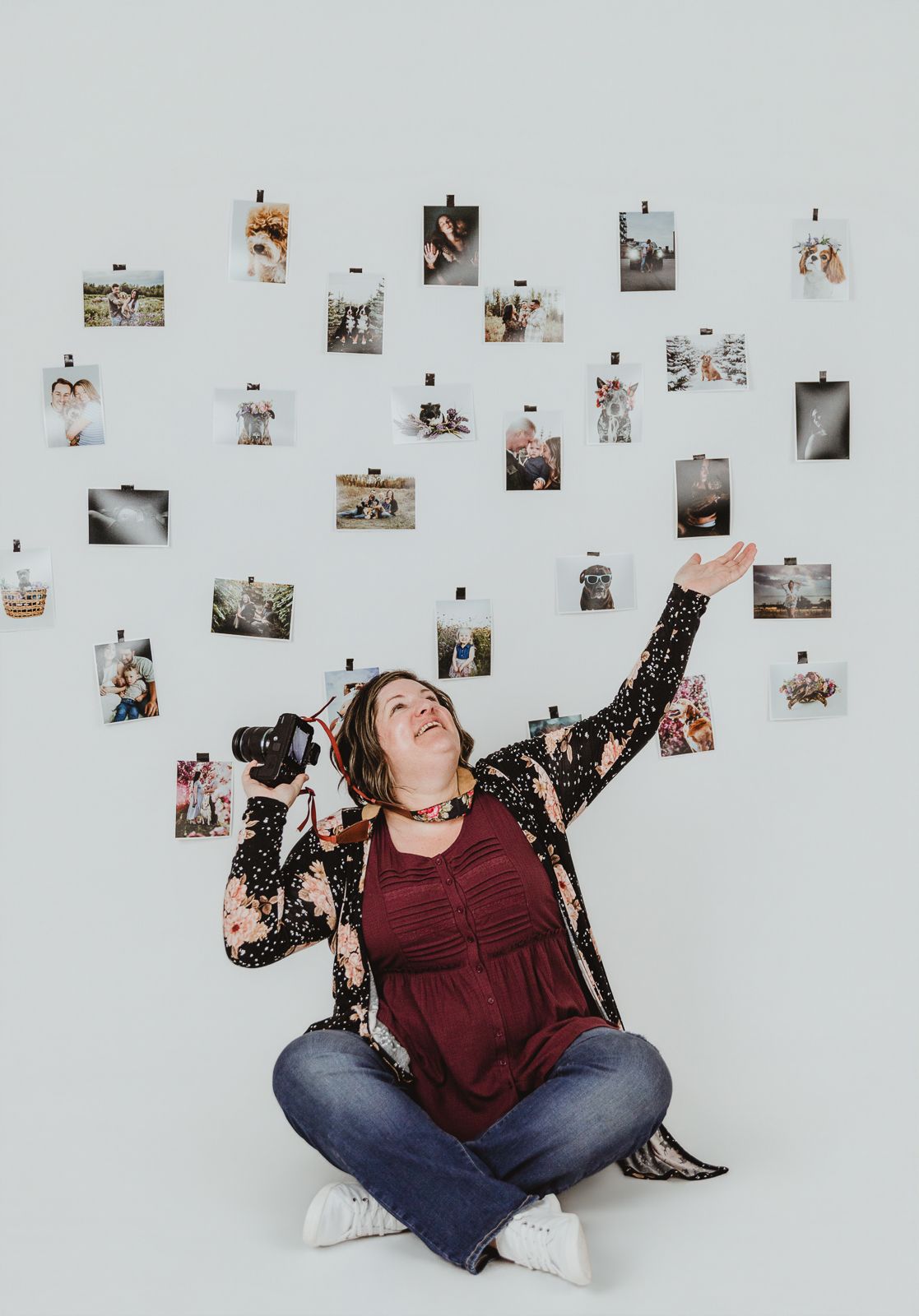 Creative branding image of Coral Konanz surrounded by her photography work in Spruce Grove, Alberta.