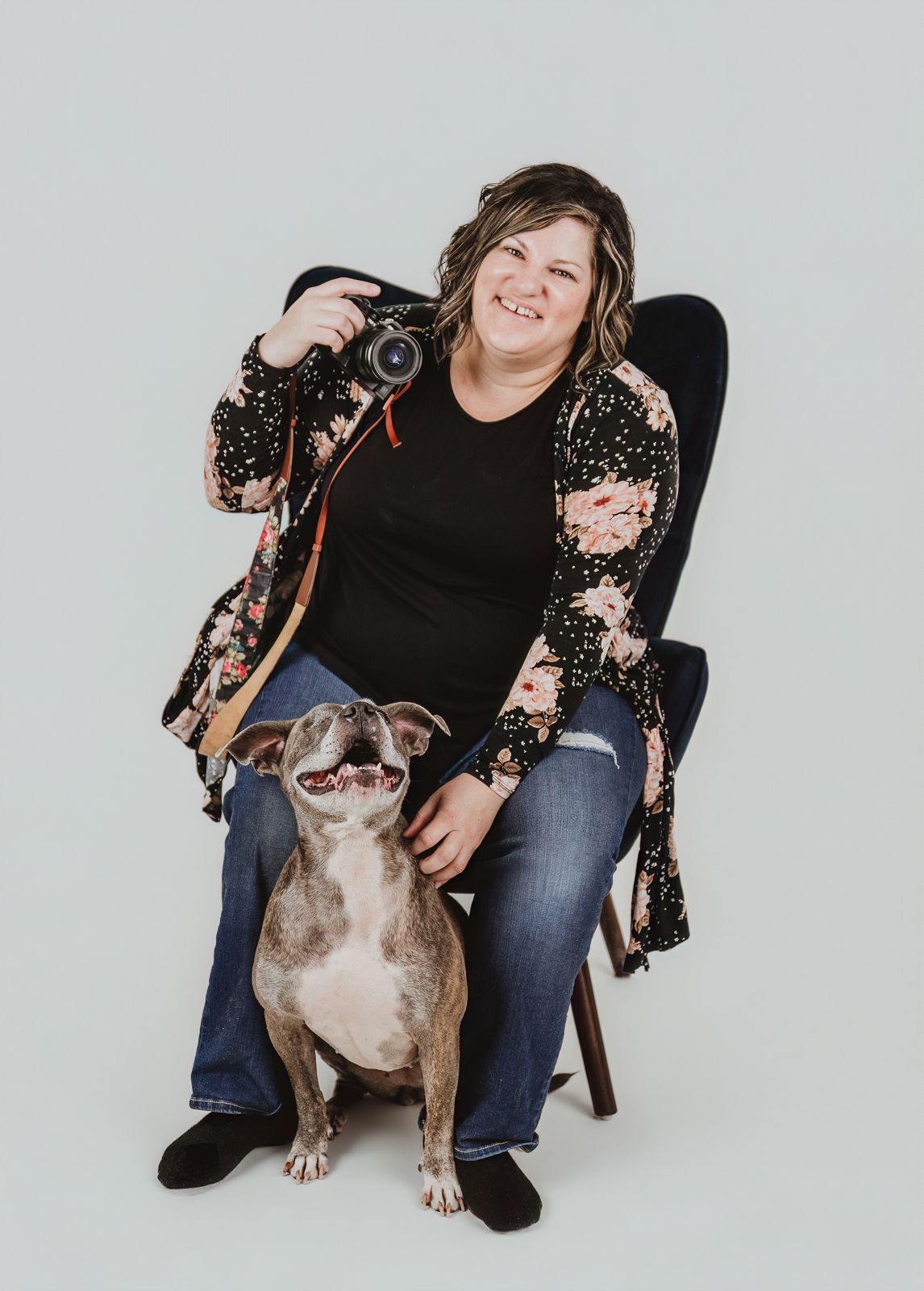 Spruce Grove dog photographer Coral Konanz sitting with a dog during a relaxed pet photography session