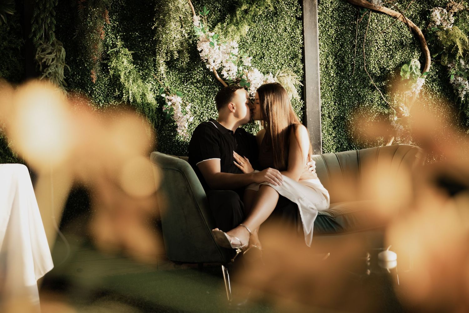 Romantic couple sharing an intimate moment seated together in a lush green garden setting in New Jersey.