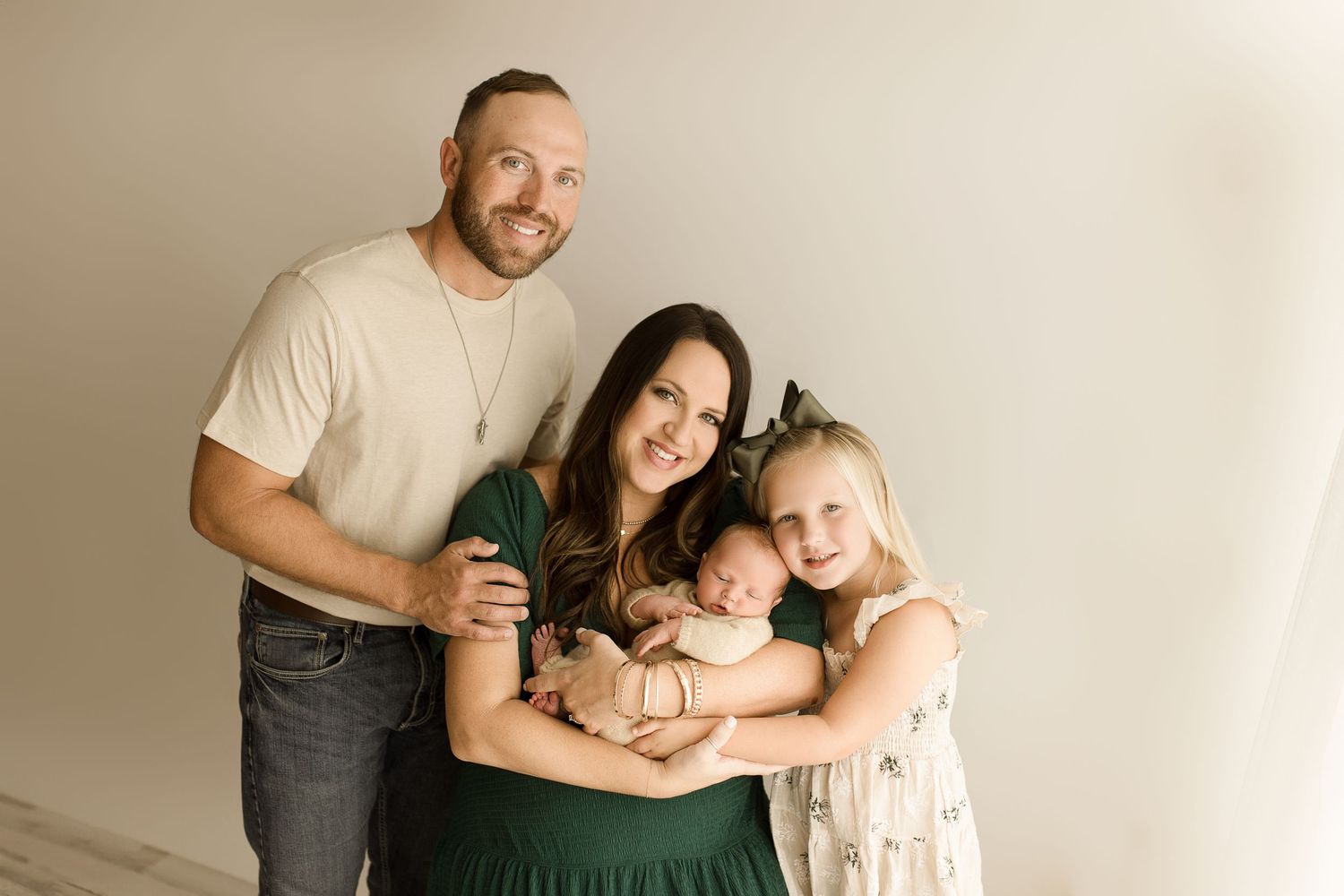 A collection of minimalist family portrait photographs against a light neutral background showing tender embraces and connections.