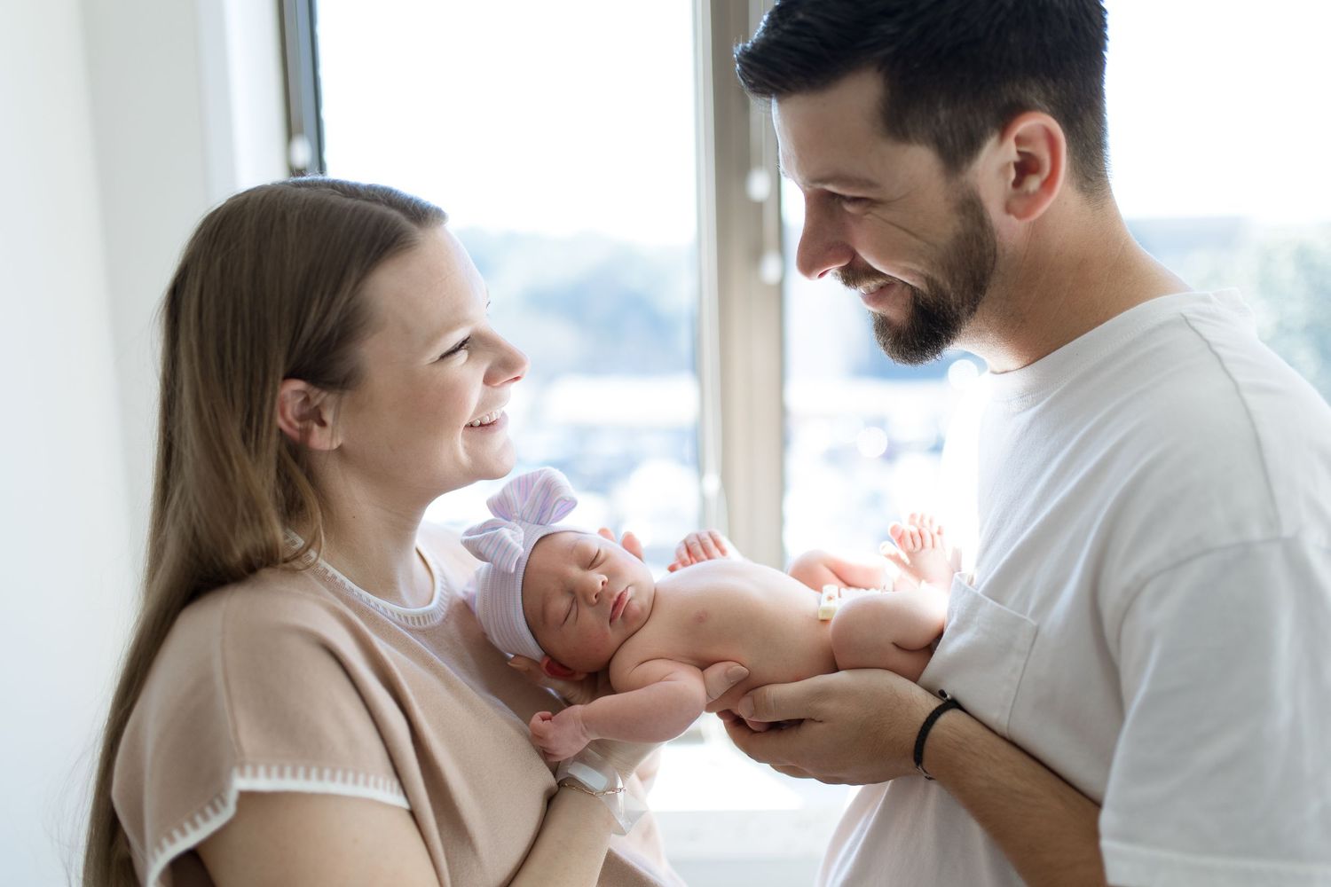 Parents holding newborn baby during their Fresh 48 session with Bree Elle Photography in Beaumont, TX at St. Elizabeth hospital.