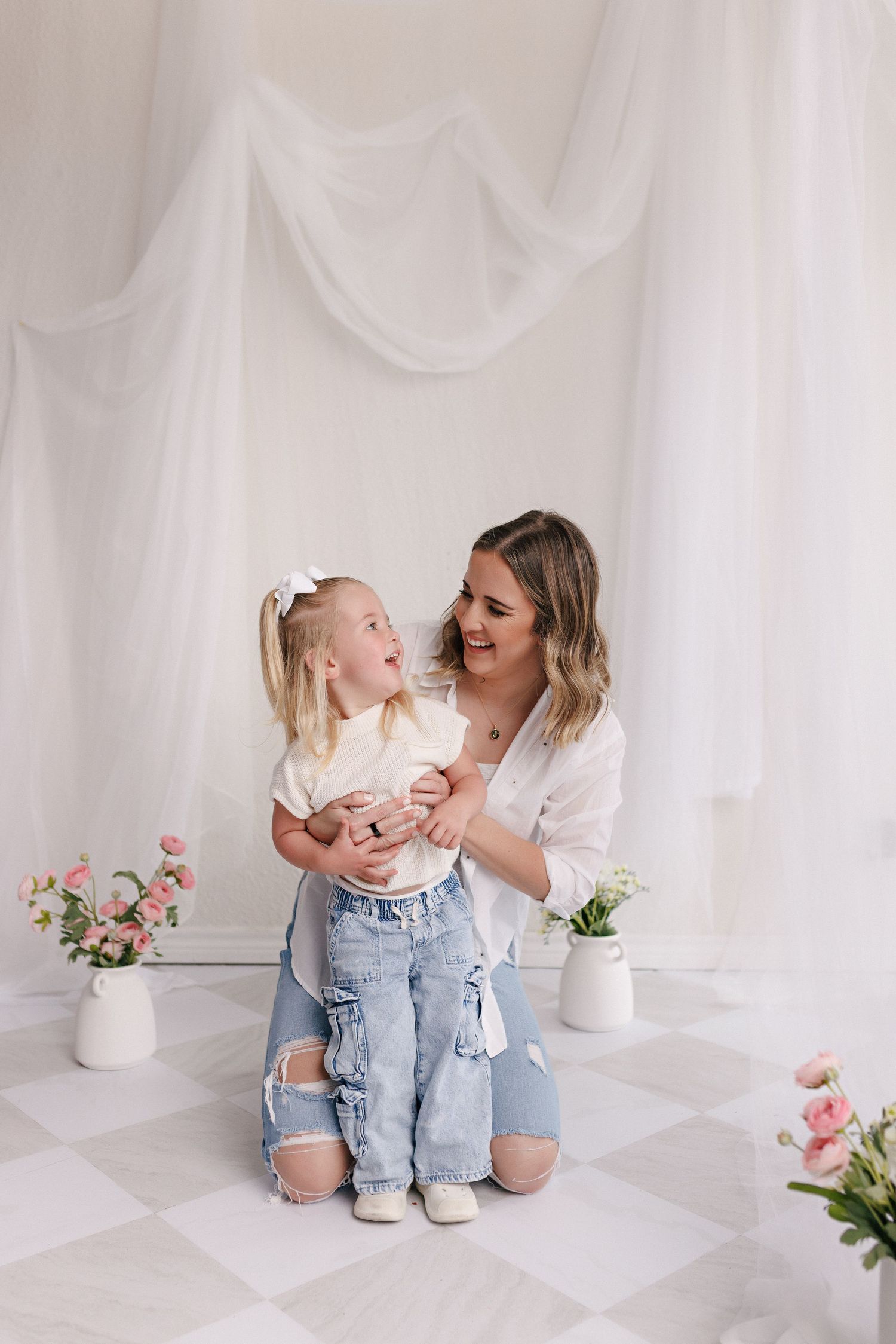 Parent and toddler in matching white tops and jeans during mommy and me session with Bree Elle Photography in Port Neches, TX.
