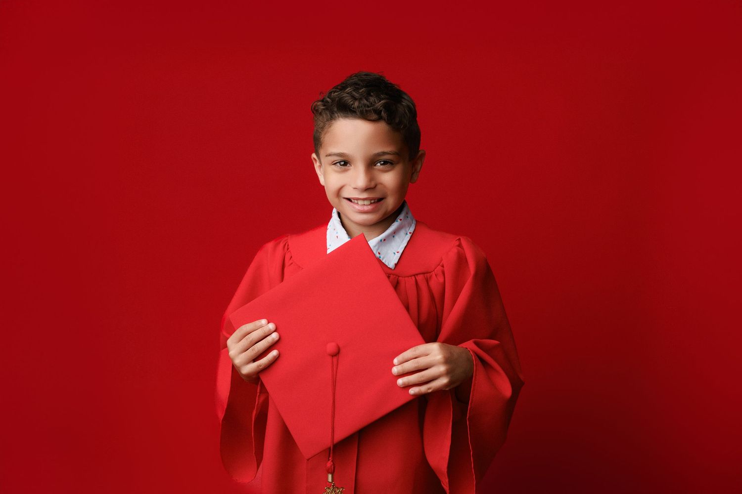 Bridge City kinder graduation portrait session with cap and gown in Port Neches, TX with Bree Elle Photography.