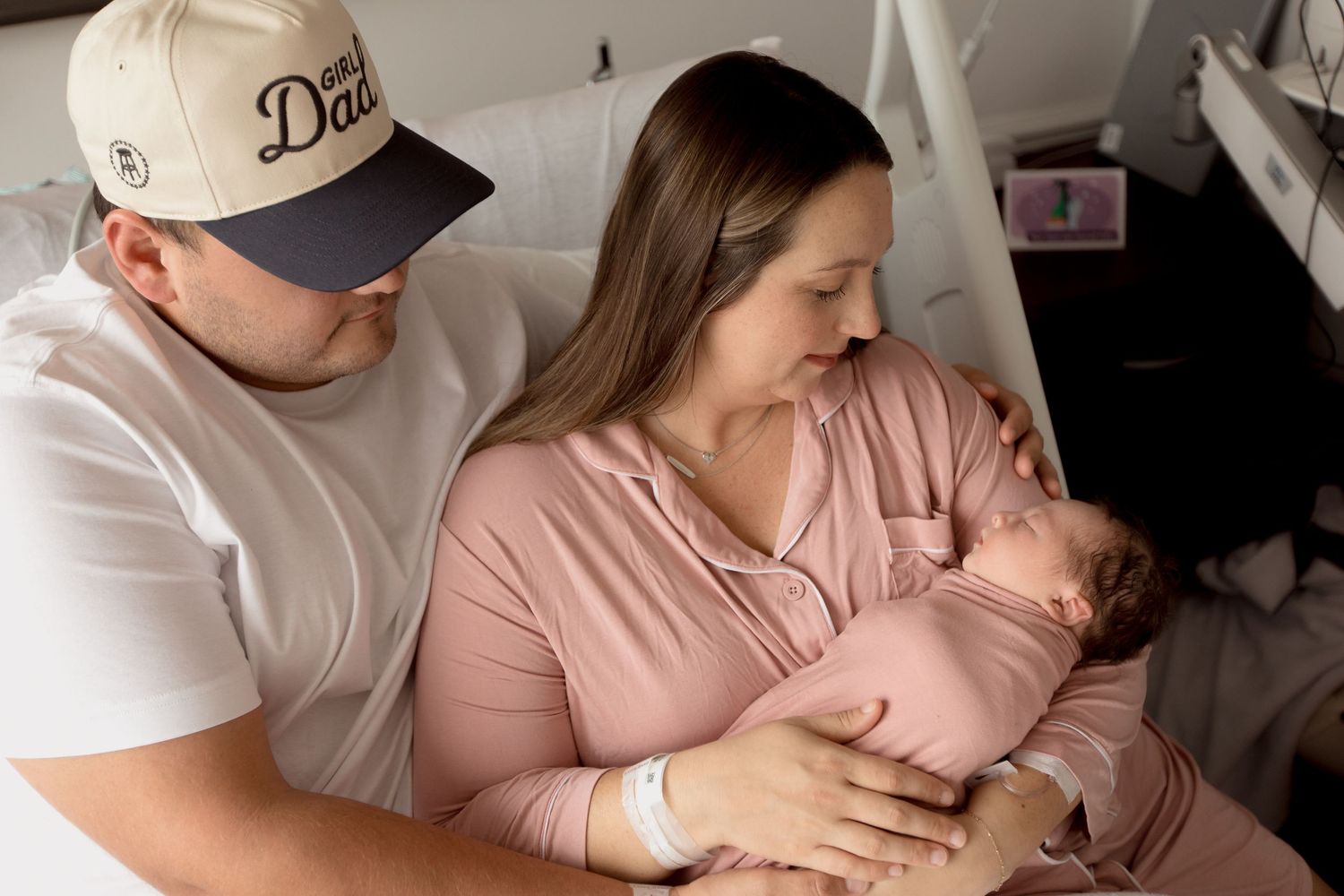 A peaceful hospital scene with soft natural lighting streaming through windows as a baby rests.