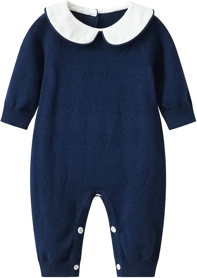 Navy blue baby romper with white Peter Pan collar and button closures at legs features a knit textured pattern.