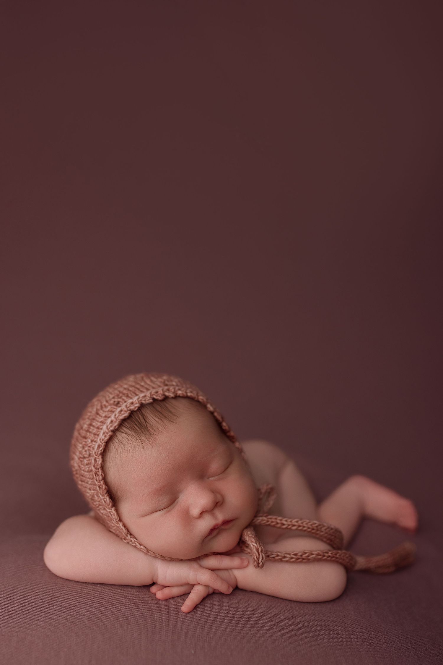 Baby girl during newborn session with Bree Elle Photography in Port Neches, TX studio.
