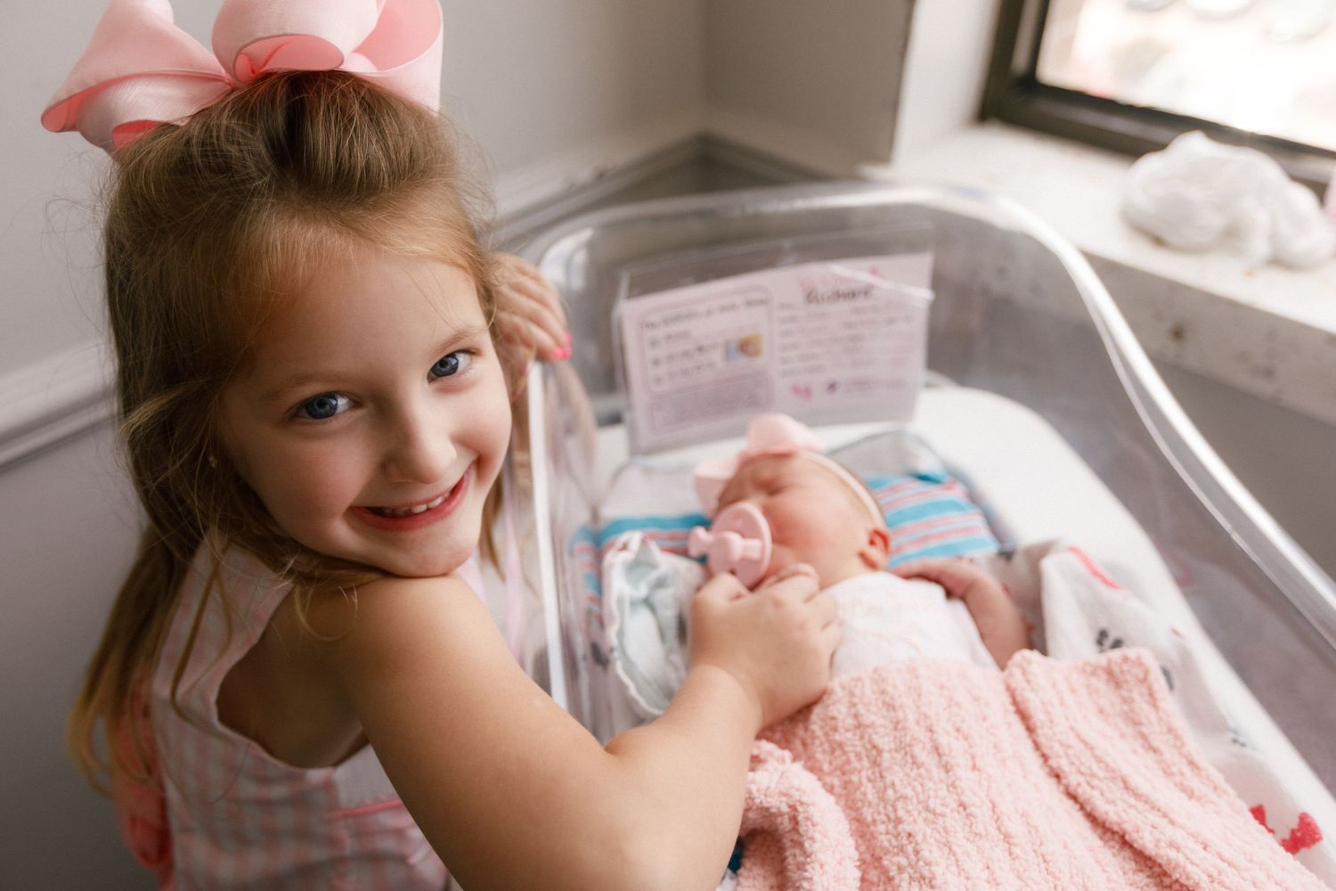 Newborn baby and older sibling during Fresh 48 session in Beaumont hospital.