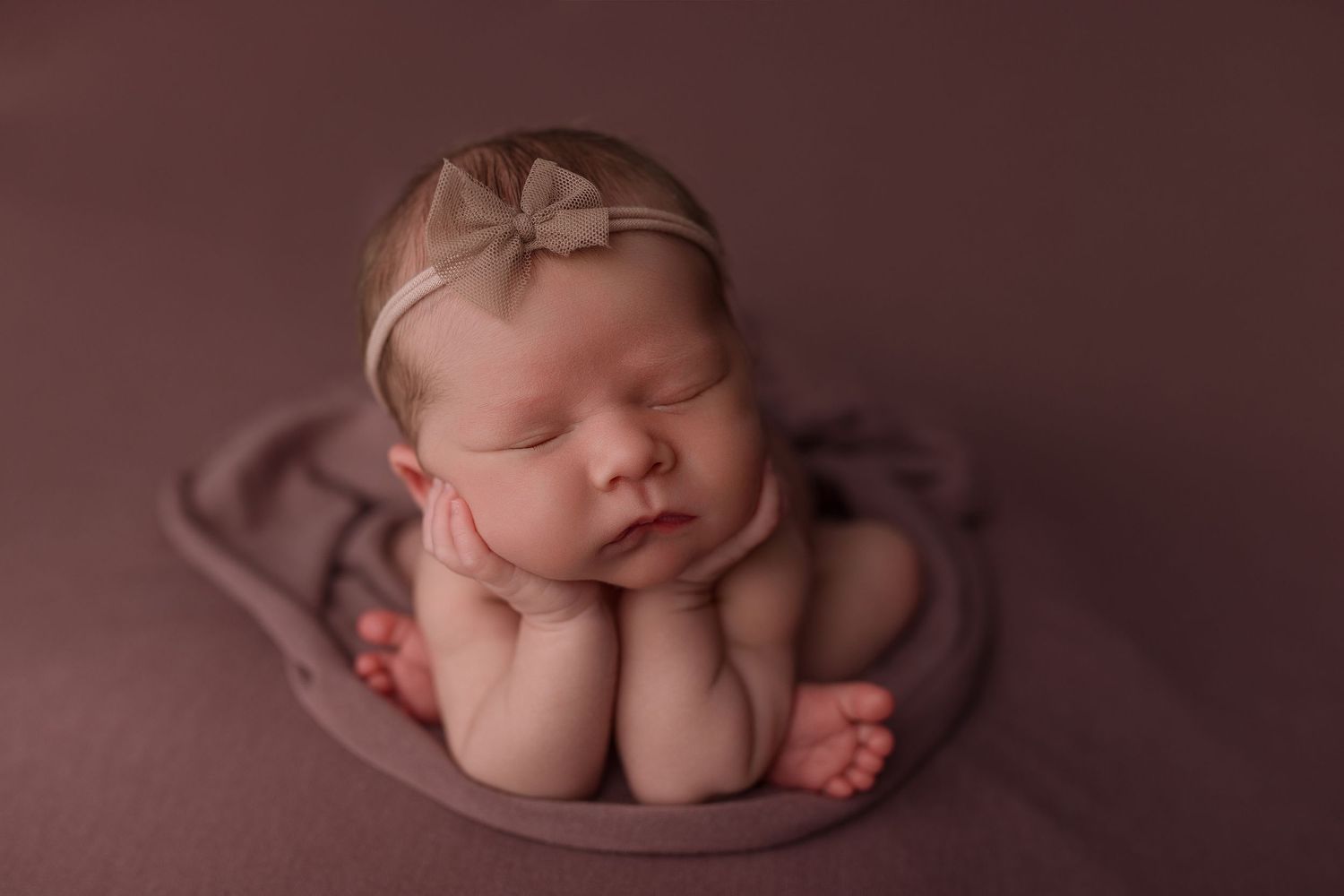 Baby girl during newborn session with Bree Elle Photography in Port Neches, TX studio.