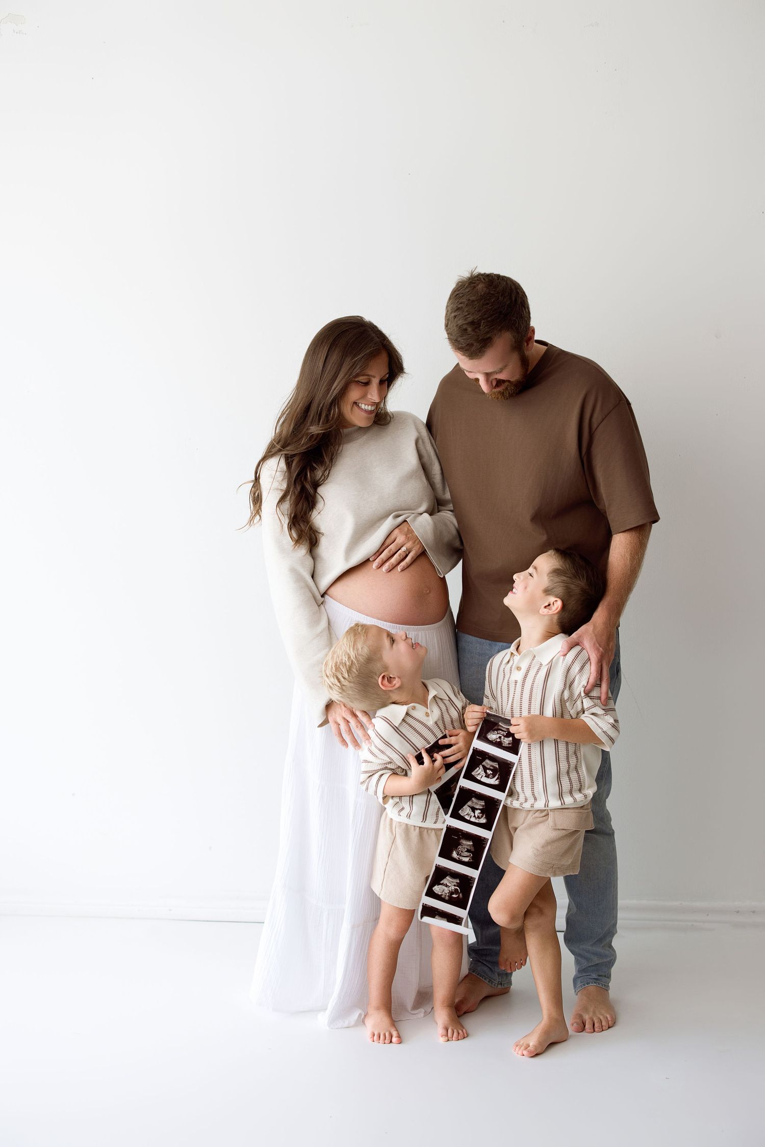 Series of four sweet minimalist family photos showing pregnancy announcement and celebration against white background.
