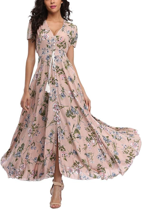 Flowy pink floral maxi dress with short sleeves, v-neck, and front slit design styled with beige sandals.