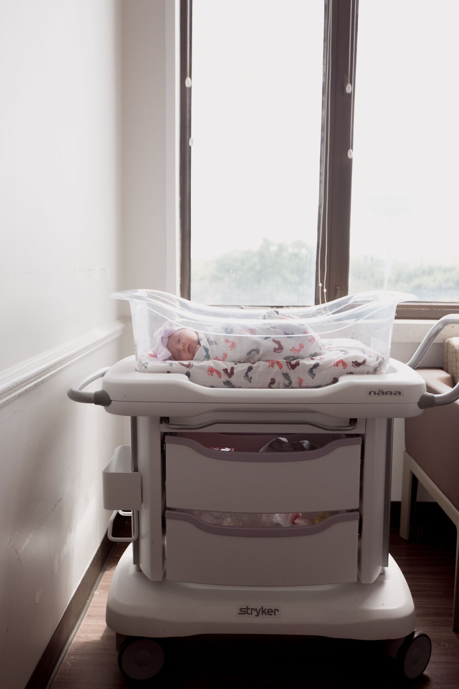 A series of five photos showing a white baby bassinet or cradle from different angles in a bright room with windows.