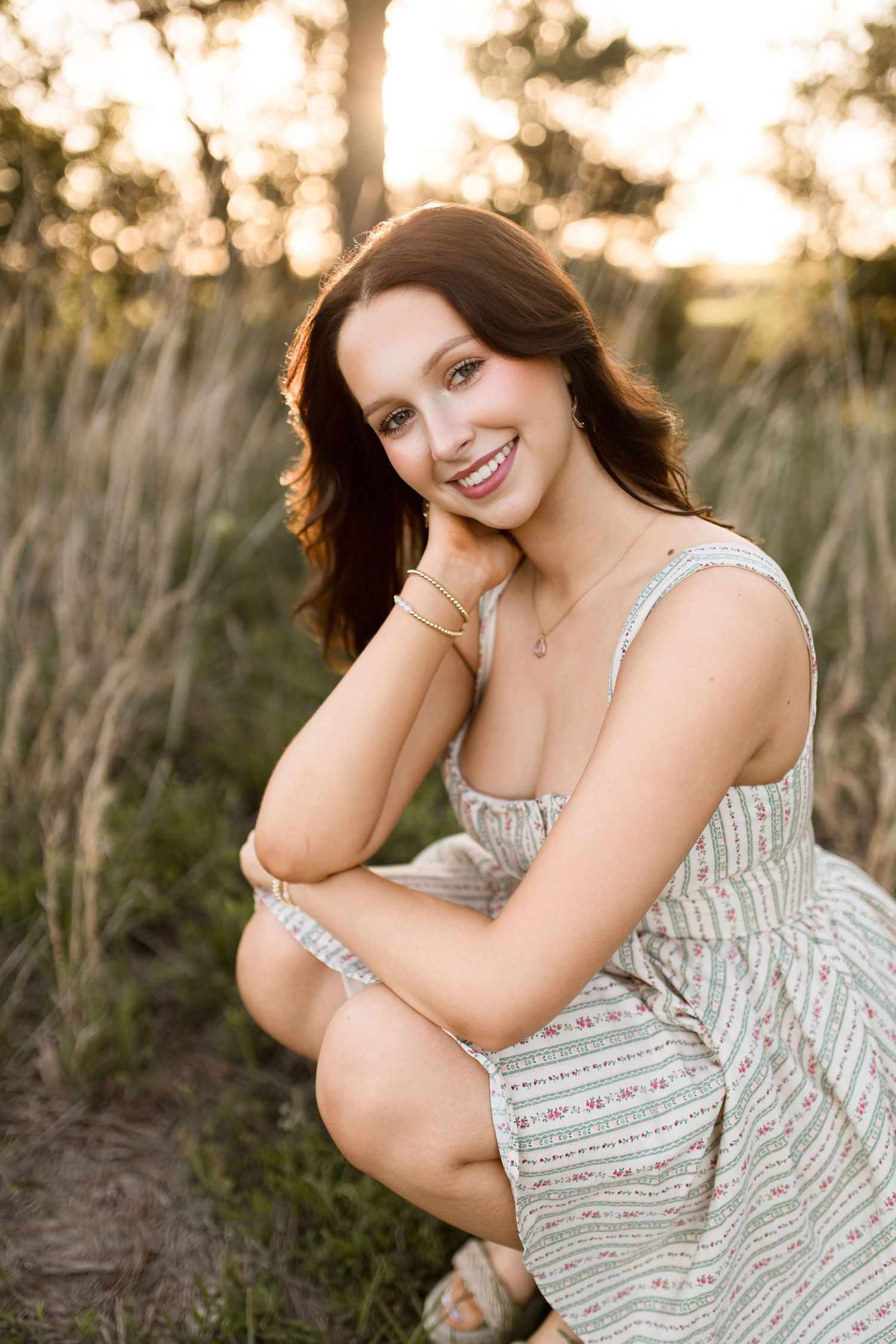 Bree Elle Photography by Alicia Stephenson with graduating senior in a field in Beaumont, TX.