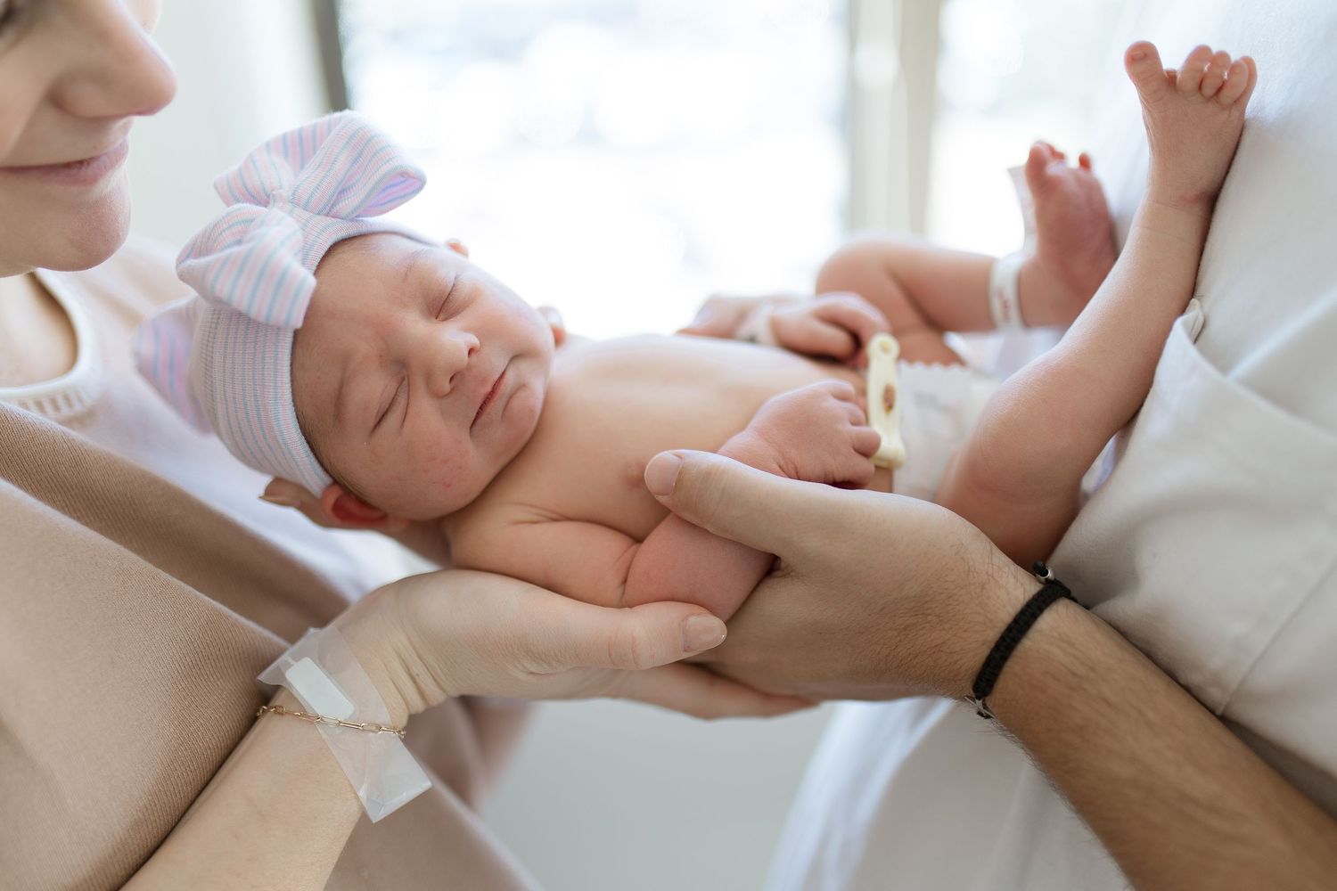 Mother and father holding their newborn baby during Fresh 48 session in Beaumont hospital.