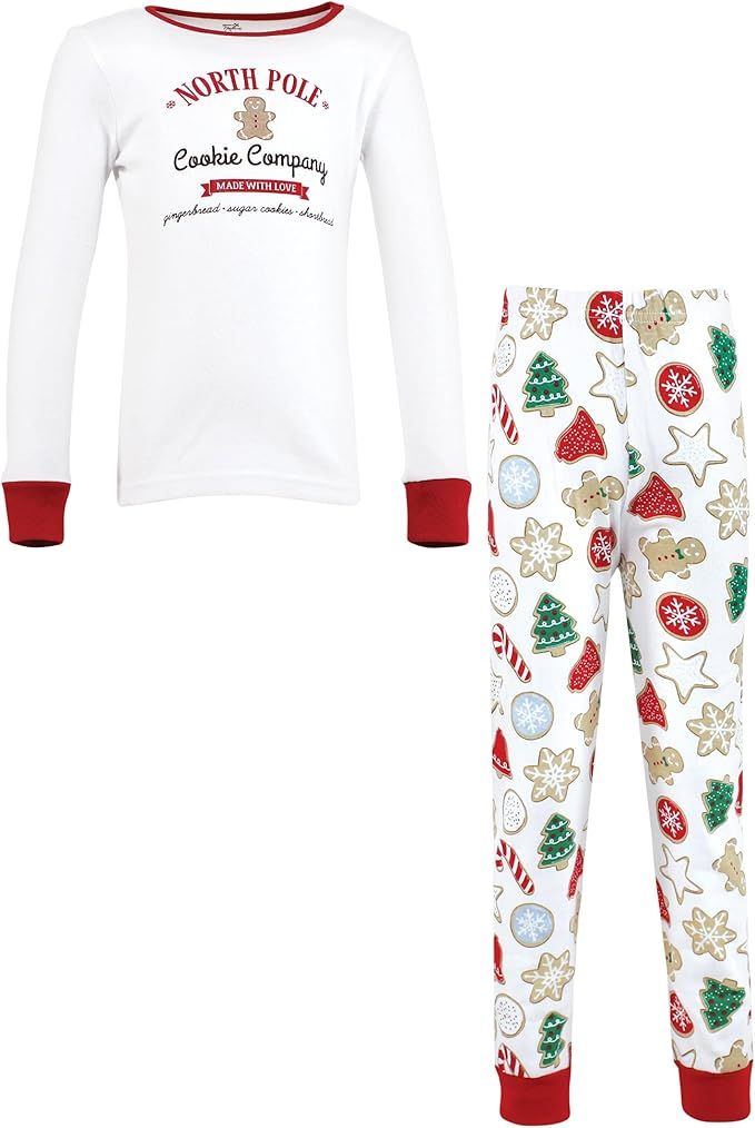 White and red Christmas pajama set with festive cookie print featuring candy canes, trees and gingerbread patterns.