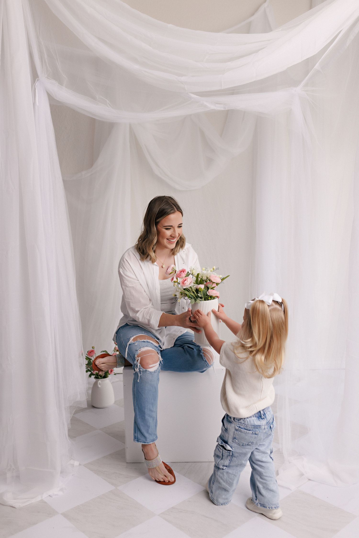 Parent and toddler in matching white tops and jeans during mommy and me session with Bree Elle Photography in Port Neches, TX.