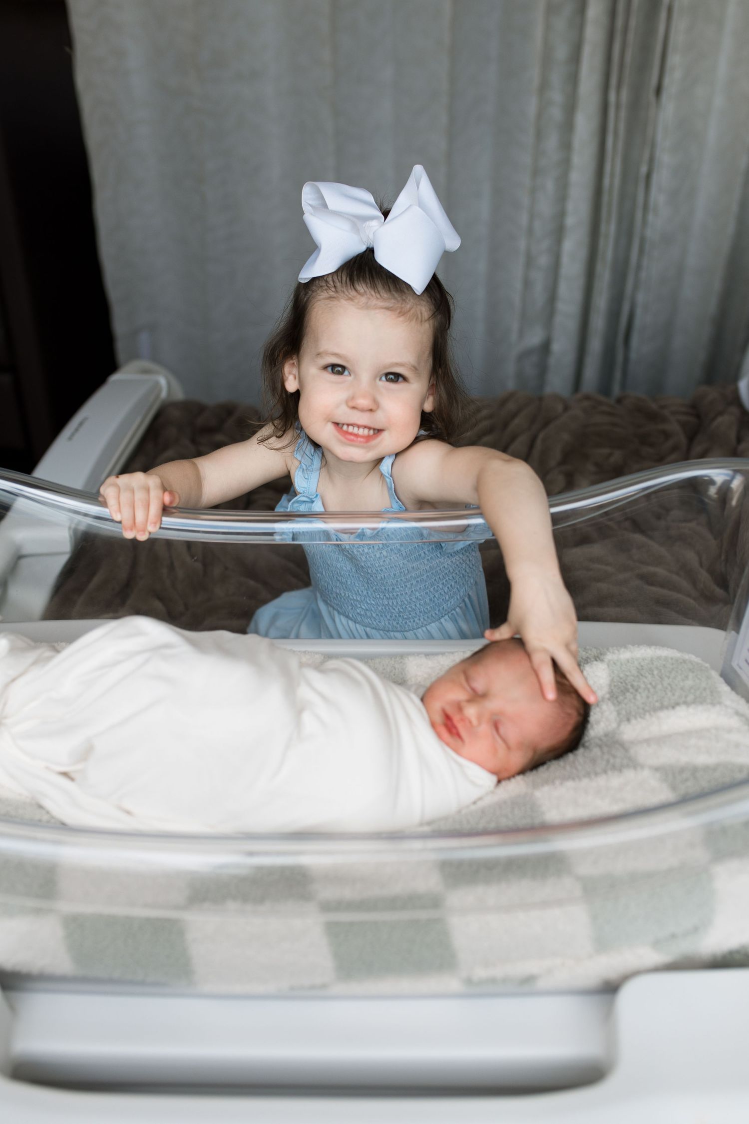 Newborn baby and sibling during Fresh 48 session at St. Elizabeth Hospital in Beaumont, TX. Photographed by Bree Elle Photography.