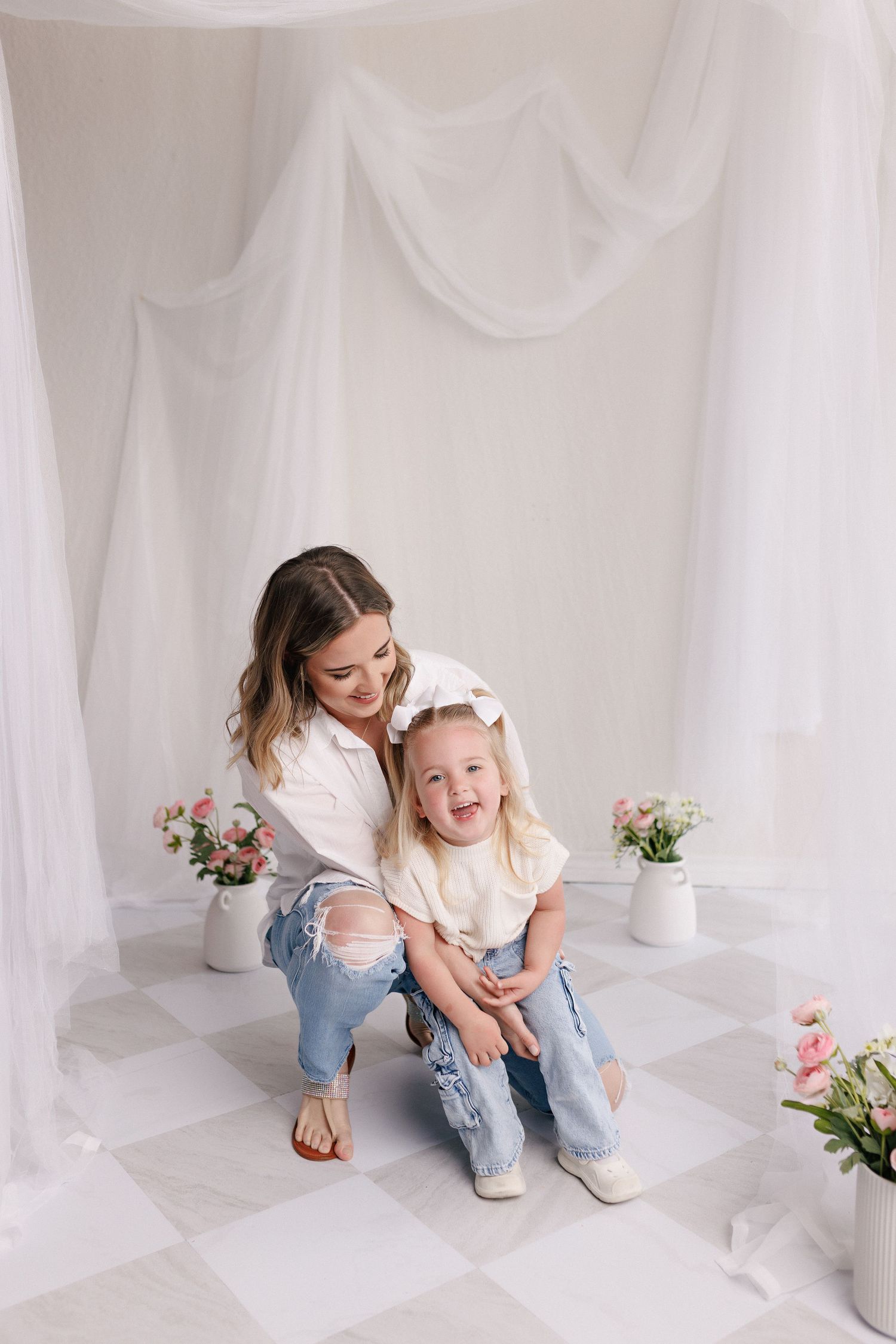 Parent and toddler in matching white tops and jeans during mommy and me session with Bree Elle Photography in Port Neches, TX.