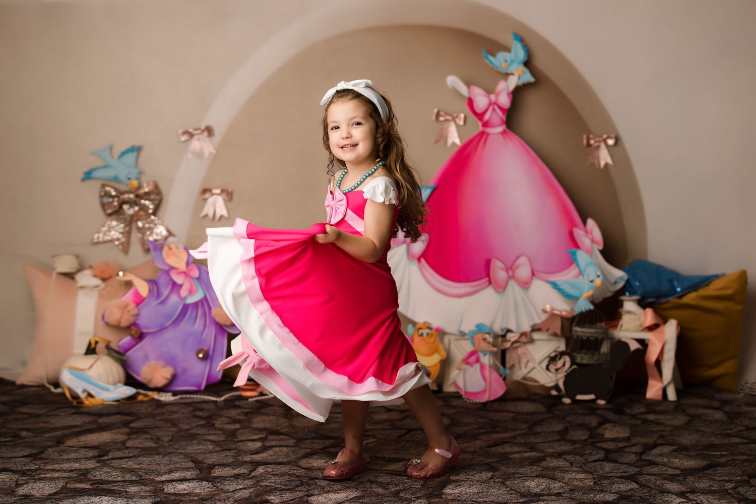 Fantasy themed portrait with pink dress and butterfly decorations in arch setting.
