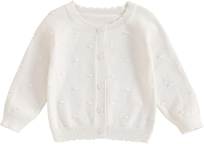 White knitted baby sweater viewed at four different angles showing buttons and delicate ribbed texture details.