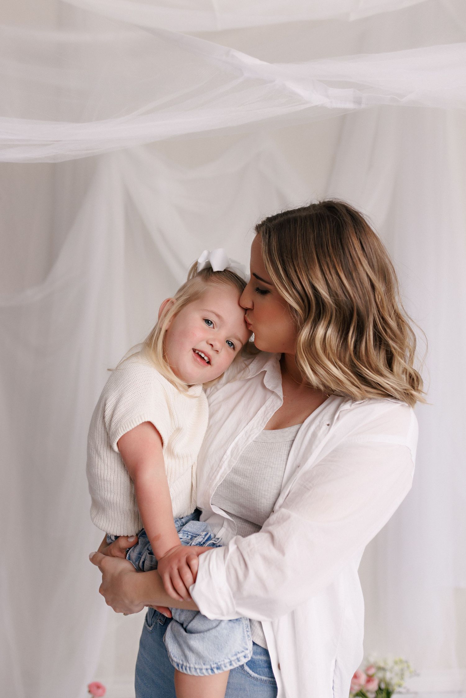 Parent and toddler in matching white tops and jeans during mommy and me session with Bree Elle Photography in Port Neches, TX.