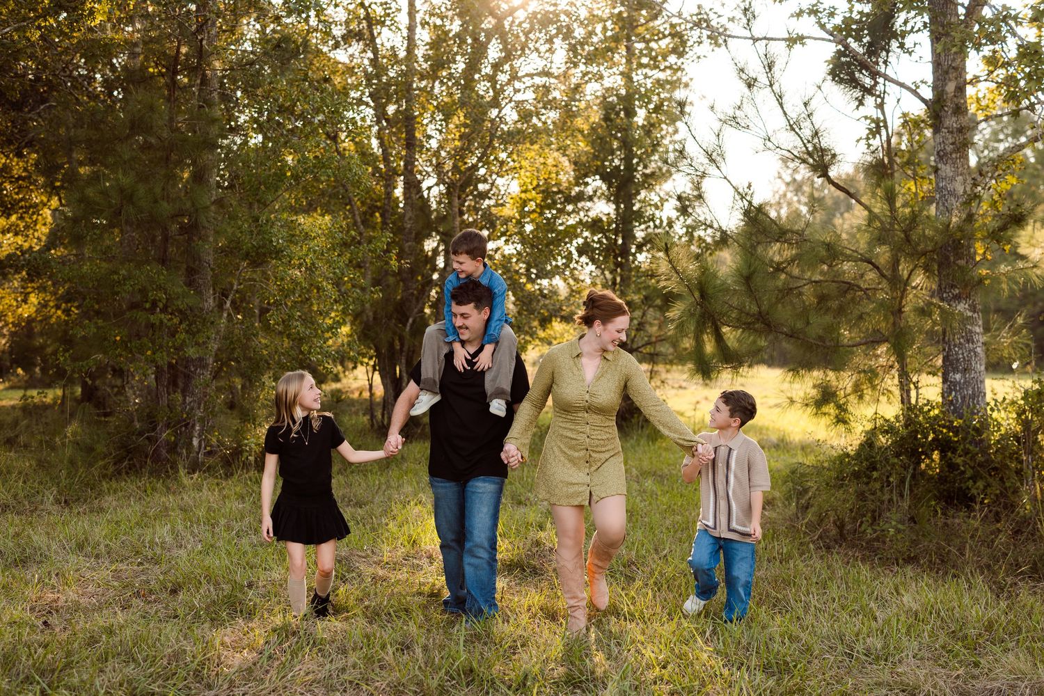 Family wearing bold fall colors during an outdoor family photography session in Southeast Texas.