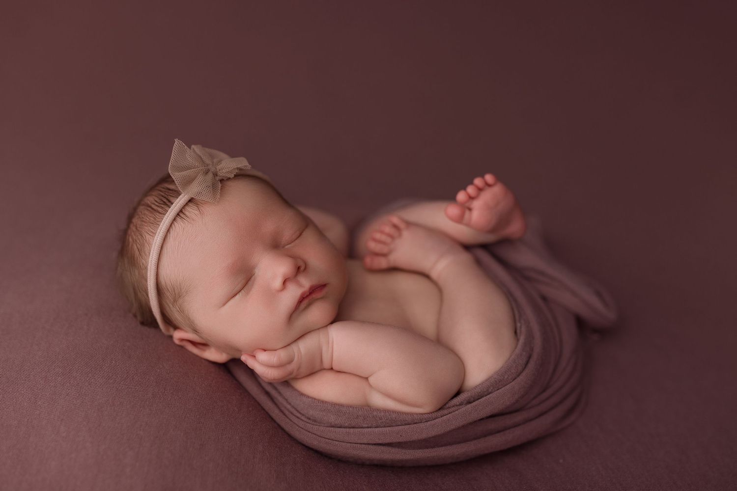 Baby girl during newborn session with Bree Elle Photography in Port Neches, TX studio.