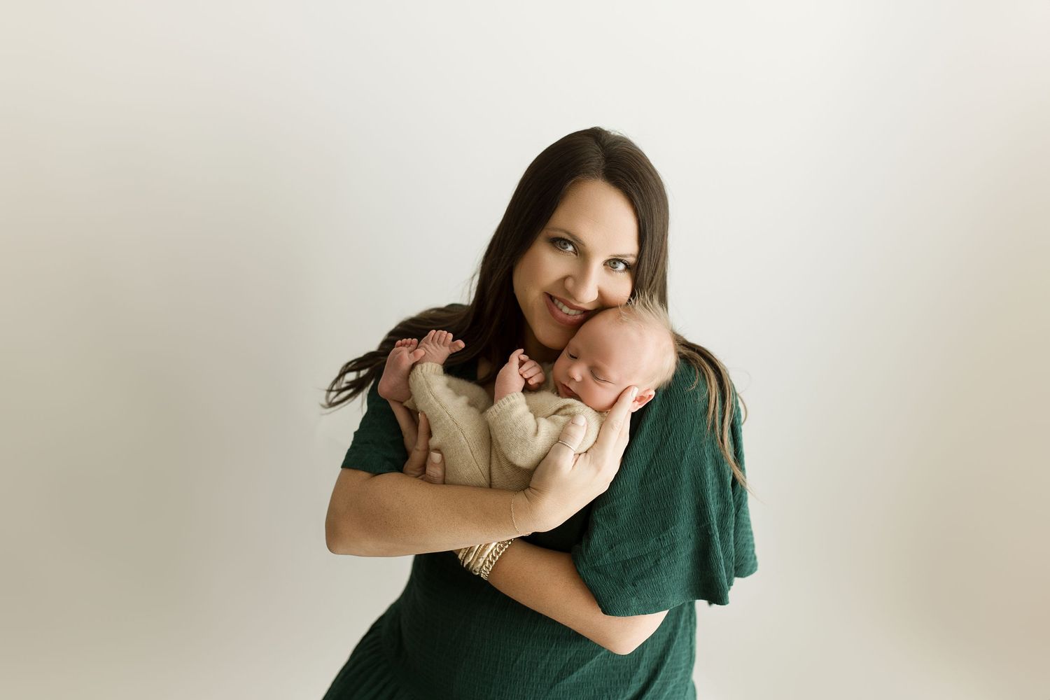 A heartwarming series of candid moments between parent and baby against a light background.