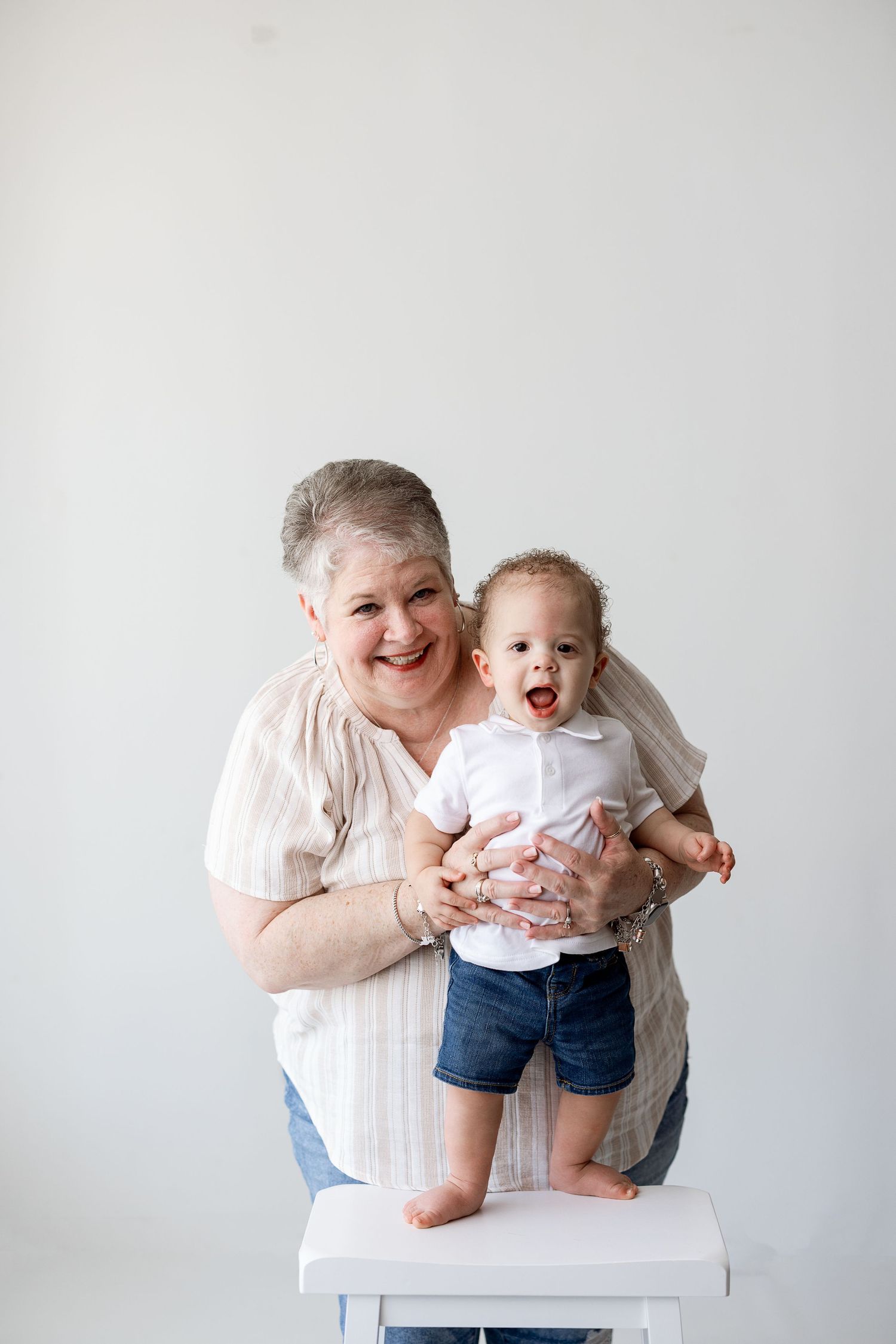 Four heartwarming candid moments showing joyful interaction and play between adult and baby on white background.