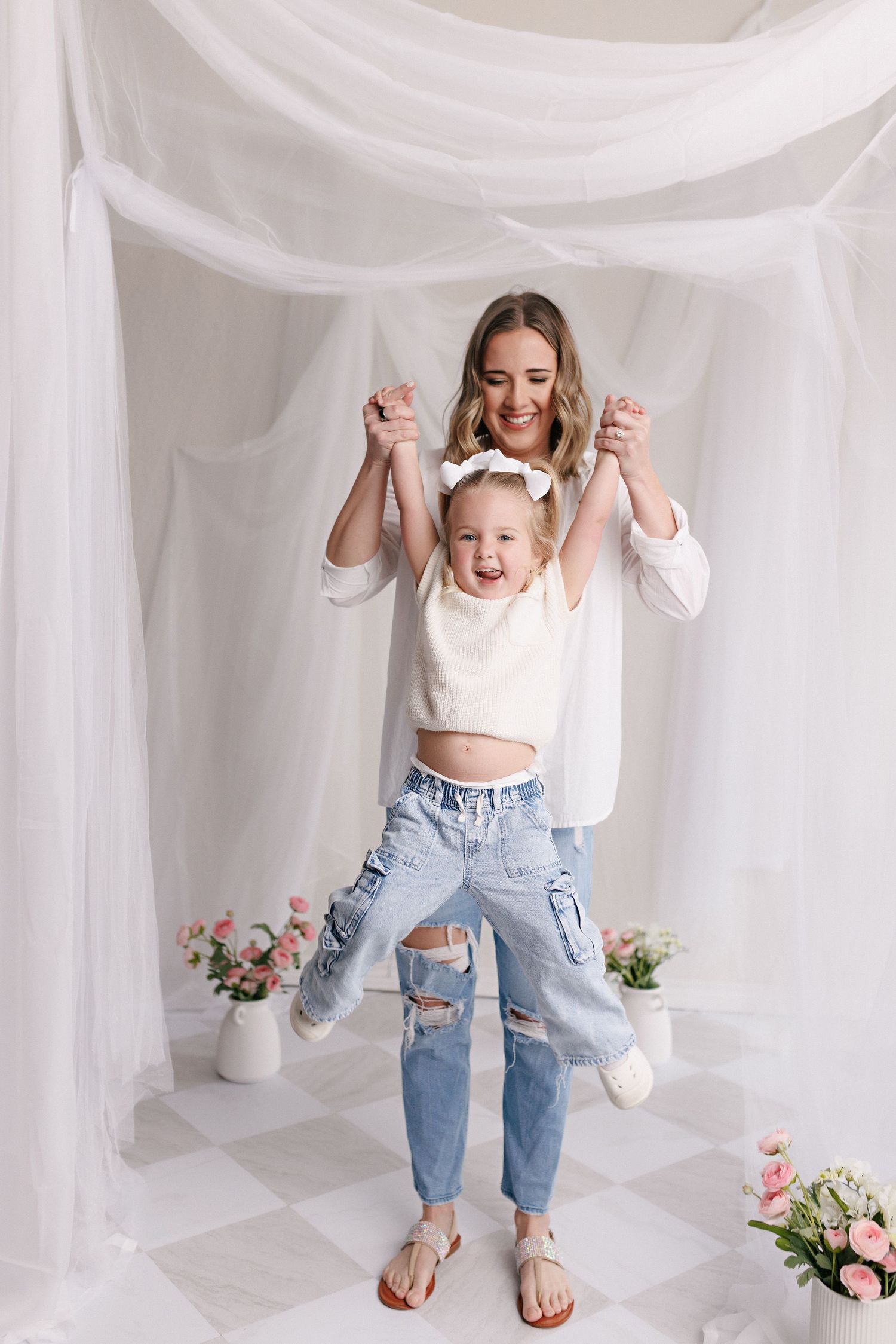 Parent and toddler in matching white tops and jeans during mommy and me session with Bree Elle Photography in Port Neches, TX.