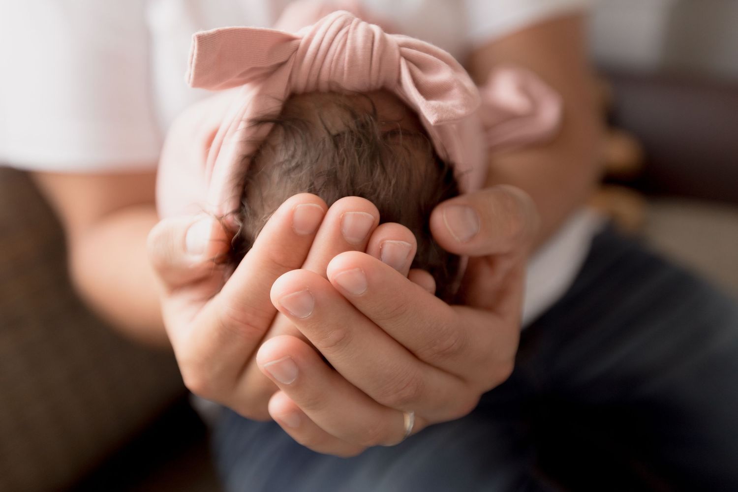 Close-up shot of hands cupping together in a warm and intimate gesture.