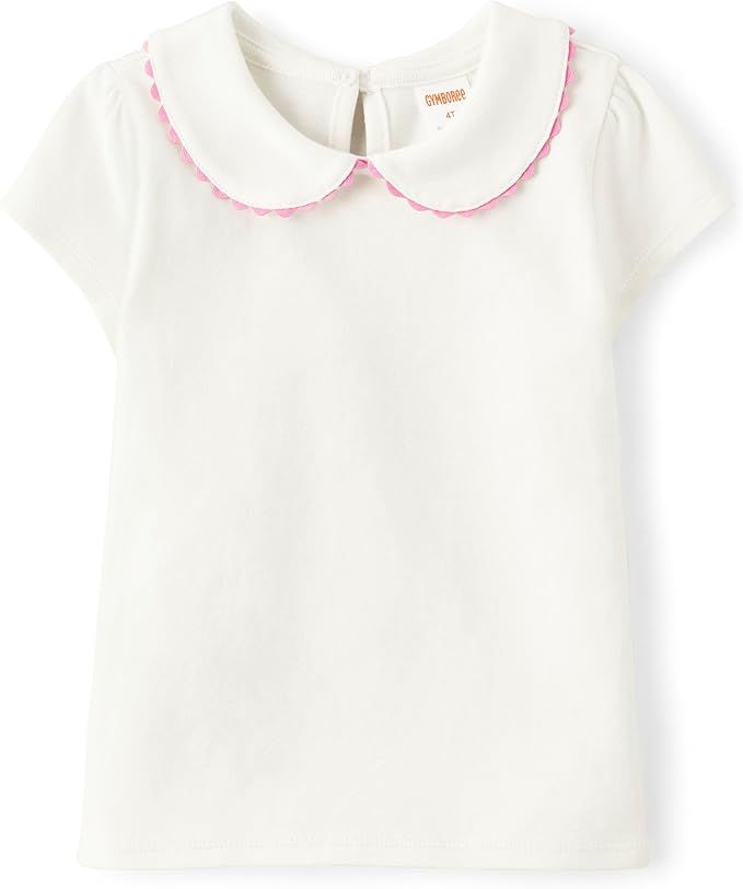 White cotton baby blouse with rounded Peter Pan collar featuring delicate pink piping trim.