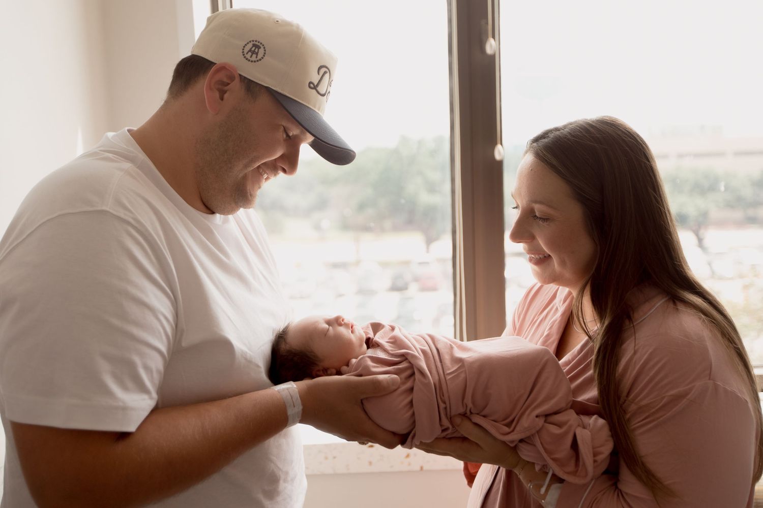 A serene moment captured in a hospital room with gentle sunlight filtering through large windows.