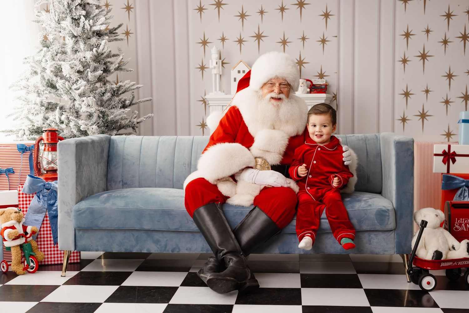 A festive holiday scene with a gray couch, star wall decor, and Christmas decorations in a modern living room setting.