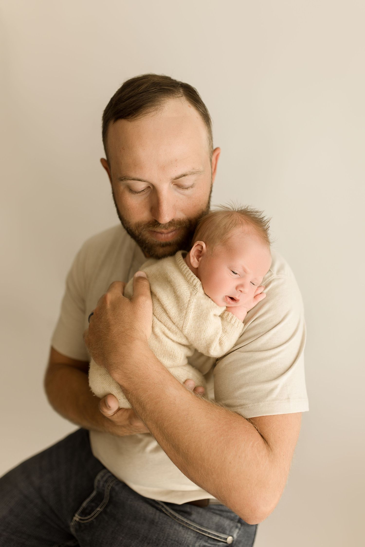A tender moment captured in a series of photos showing a parent cradling and embracing a sleeping newborn baby.