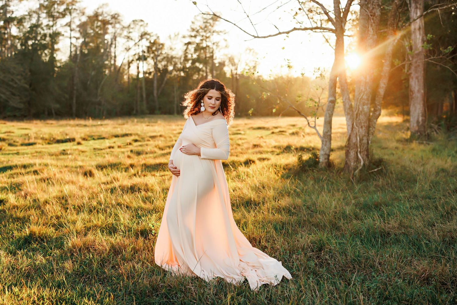 Sunset maternity session in grassy field with golden light with Bree Elle Photography in Orange, TX.