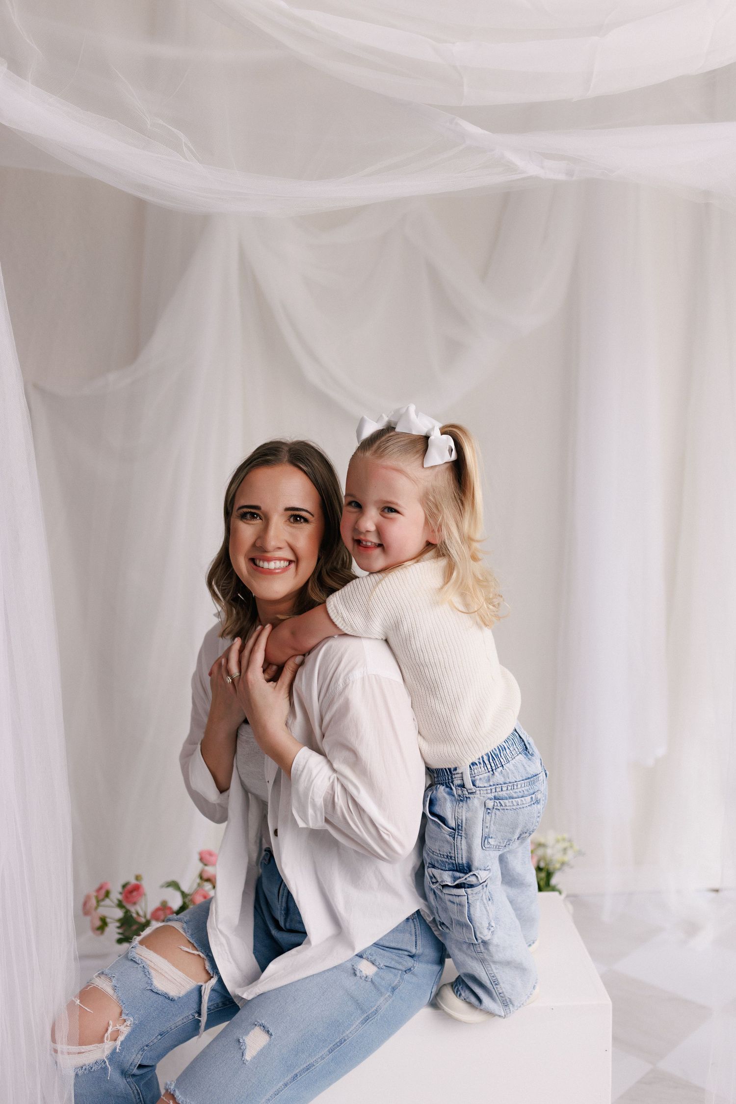 Parent and toddler in matching white tops and jeans during mommy and me session with Bree Elle Photography in Port Neches, TX.