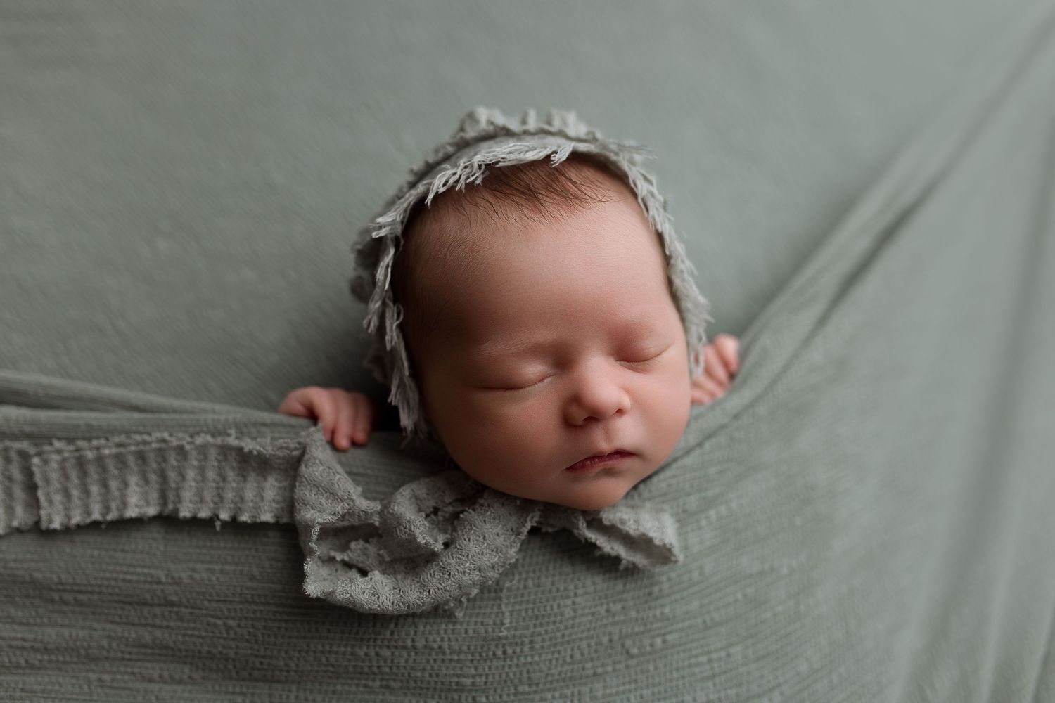 Baby girl during newborn session with Bree Elle Photography in Port Neches, TX studio.